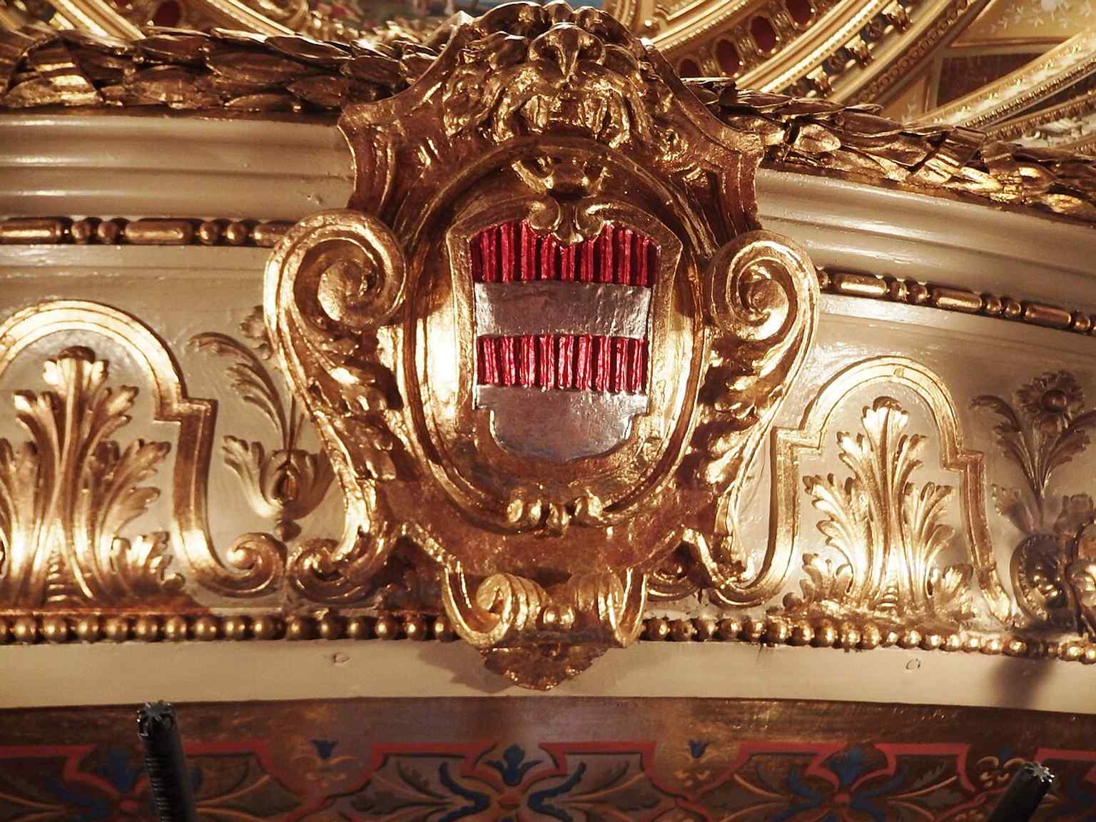 The Brno coat of arms inside the theatre connects the building to the city that financed and proudly opened this advanced new house.