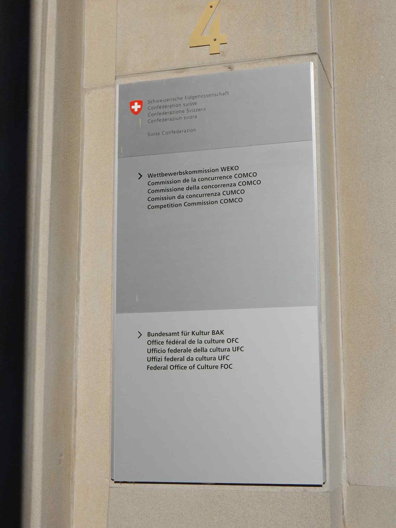 The entrance sign of the Swiss Competition Commission (WEKO) at Hallwylstrasse 4 in Bern, marking the official seat of Switzerland's competition authority as of 2021.
