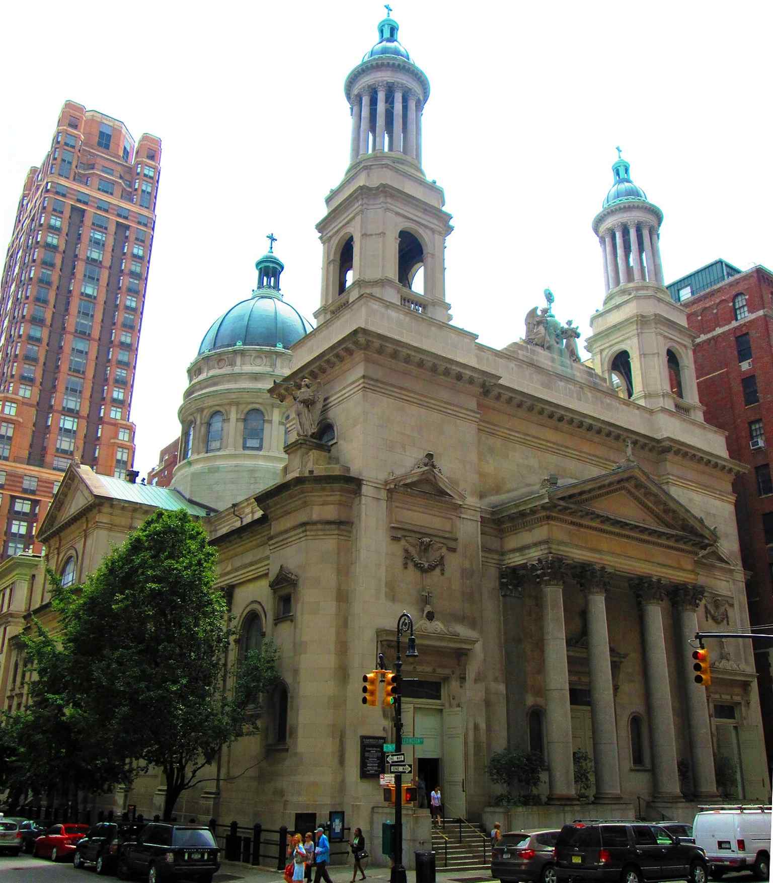 This view shows the St. Jean Baptiste Church and its rectory, which were collectively listed on the National Register of Historic Places in 1980.
