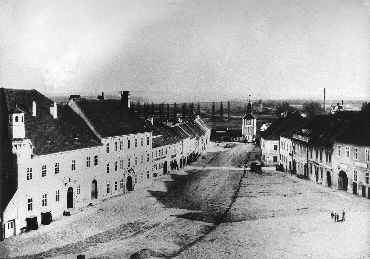 This late 19th-century view from the castle stables shows the Palackého náměstí, with the Hodinová brána (Clock Gate) visible at the southern end before its demolition in 1903.