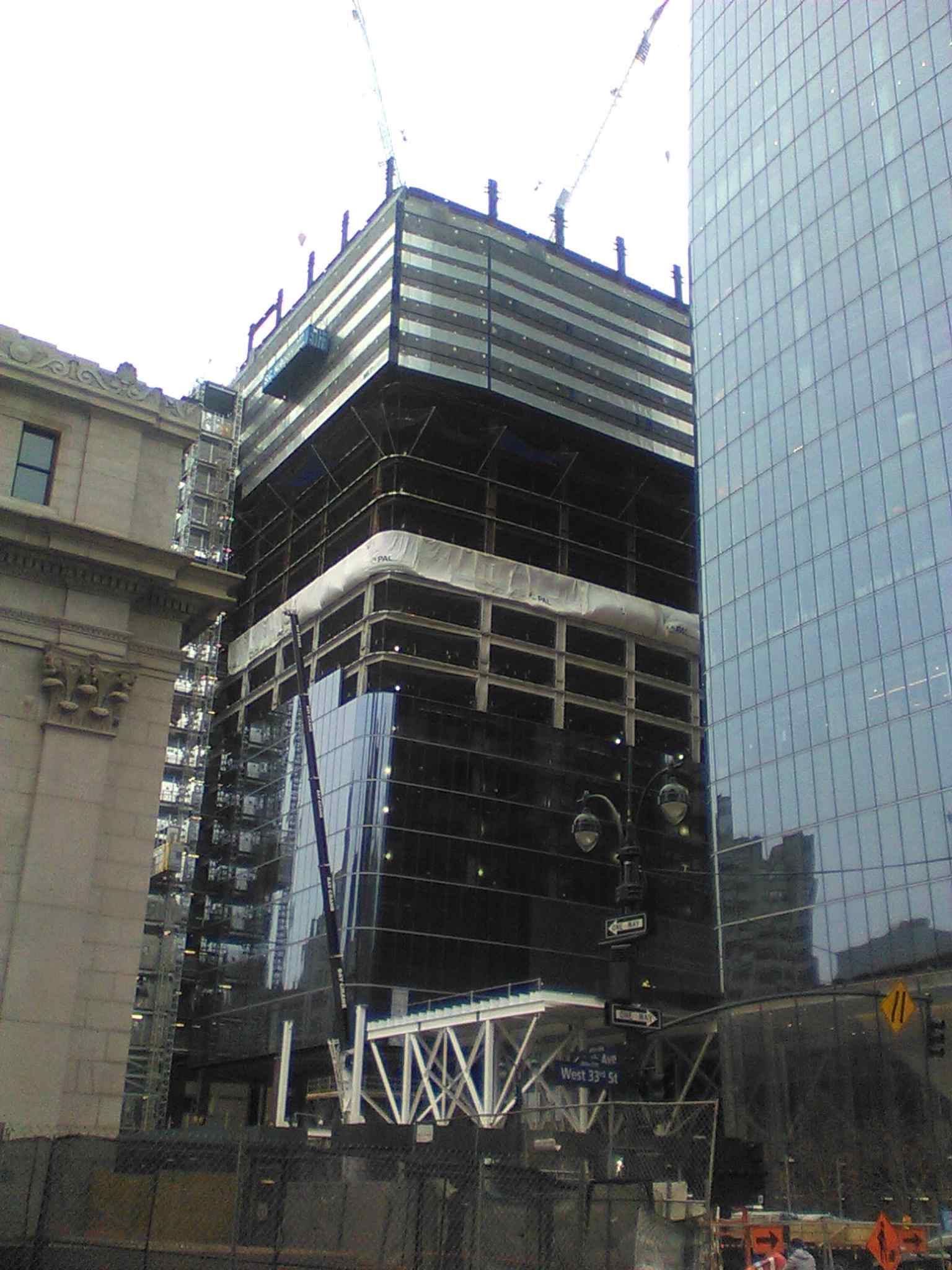 Two Manhattan West’s glass tower rising over 31st Street — part of the mixed-use Manhattan West complex built above Penn Station storage tracks.