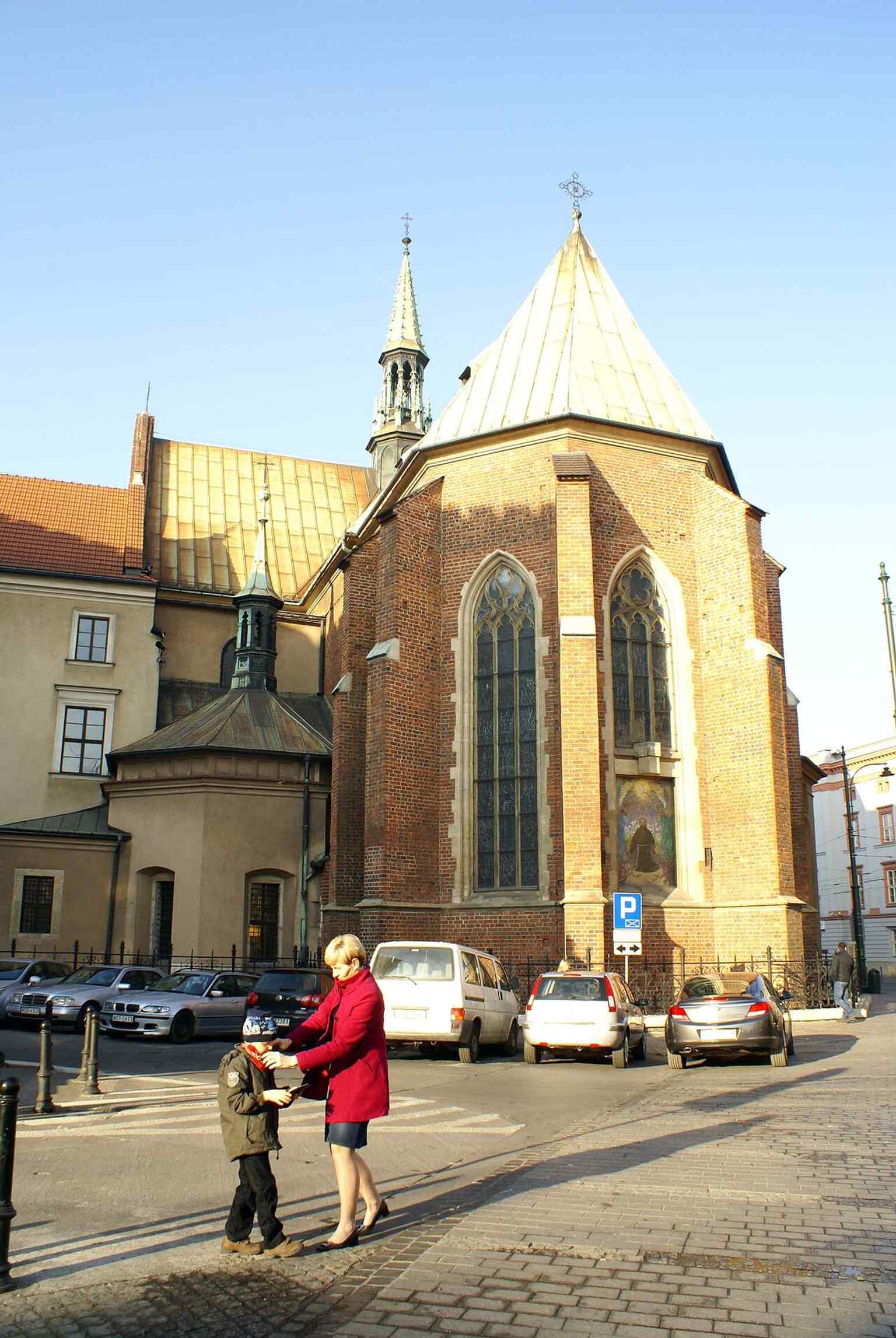 A clear street-side view of the church facade in Kraków, useful for introducing the basilica’s place on the edge of the Old Town.