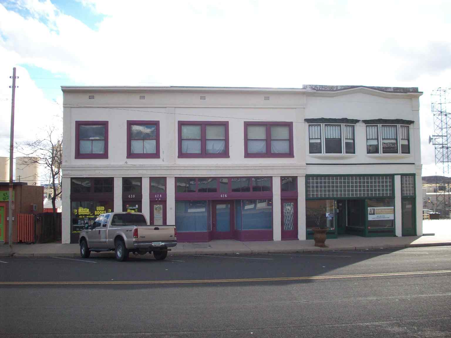 The Armour and Jacobson Building, completed in 1921, featuring its original white stucco exterior and clerestory windows designed to flood the interior with natural sunlight.