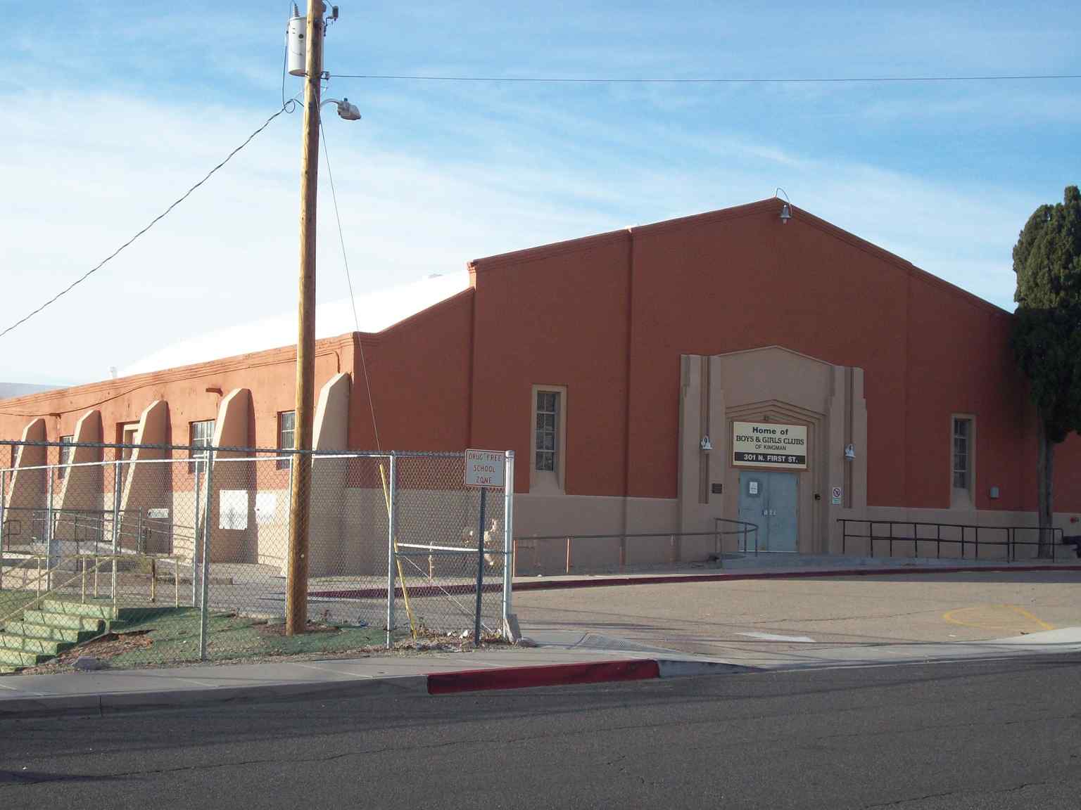 A broad exterior perspective of the Mohave Union High School Gymnasium captured in 2012, showcasing the distinct Moderne architectural style and structural supports.