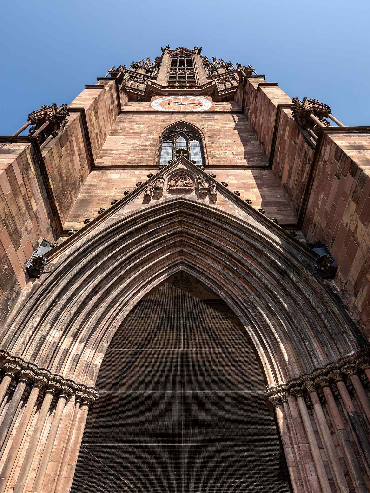 The tower and main portal together, showing the dramatic verticality that made Freiburg famous.