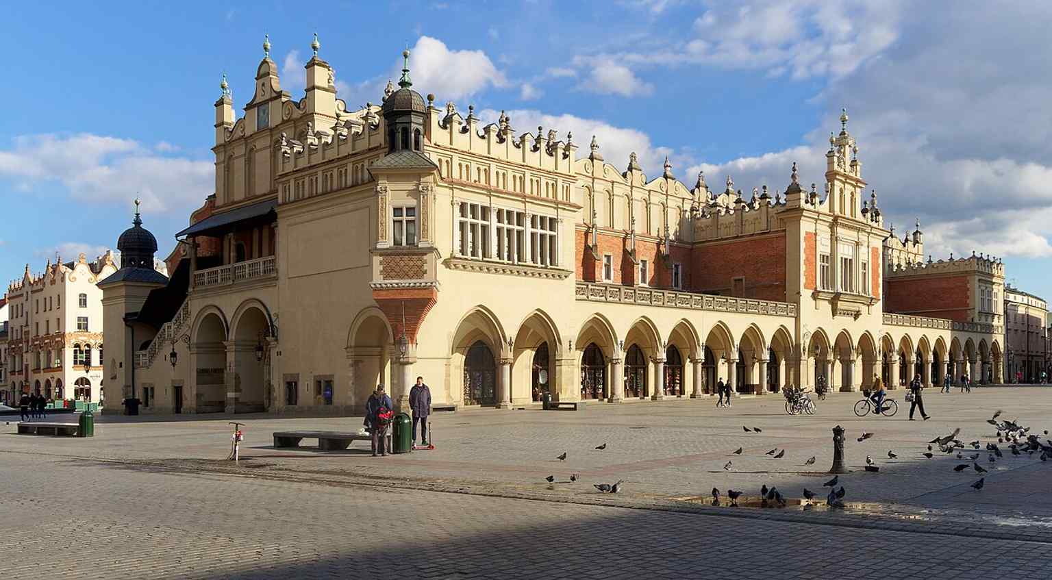 The west side of the Cloth Hall, useful for showing the building’s Renaissance façade and the restored market hall that replaced earlier medieval stalls.