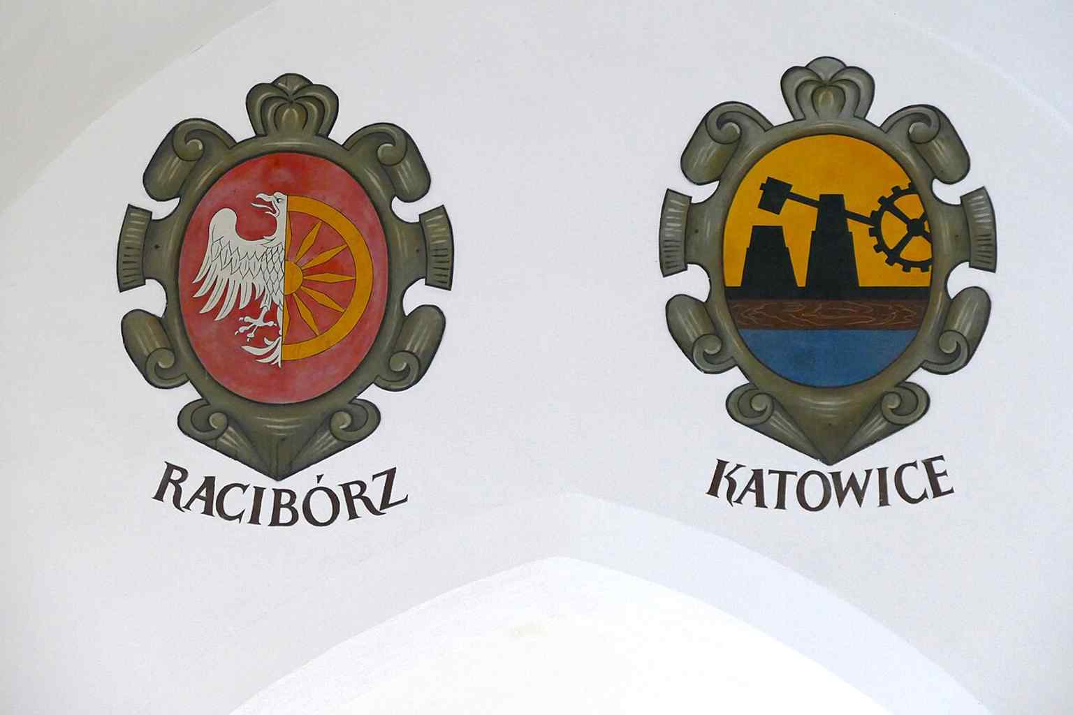 A close-up of the decorative city coats of arms inside Sukiennice, reflecting the 19th-century interior decoration added during the Pryliński reconstruction.
