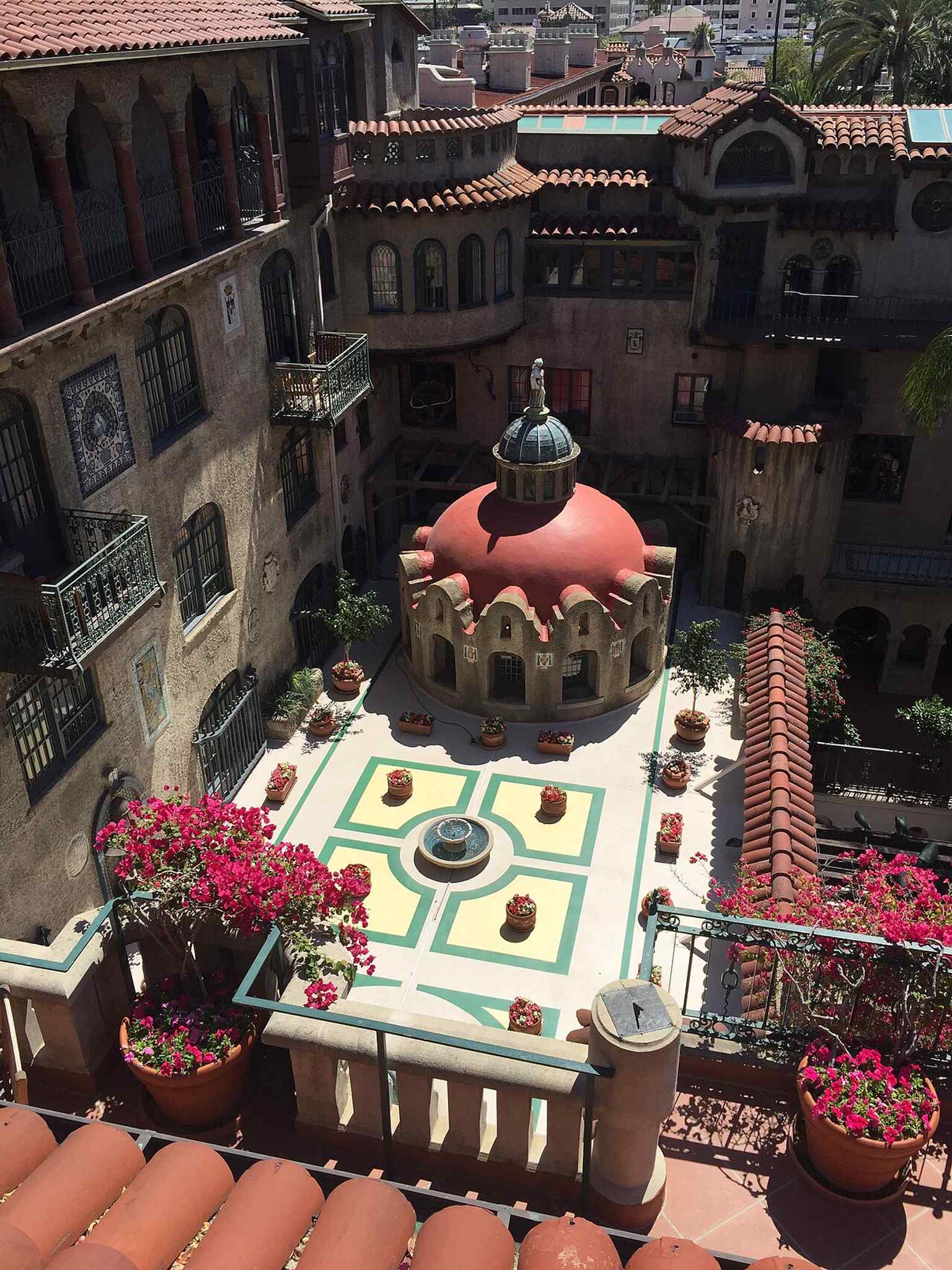 A rooftop view over the central plaza shows the inn’s dense architectural layout and interconnected courtyards.