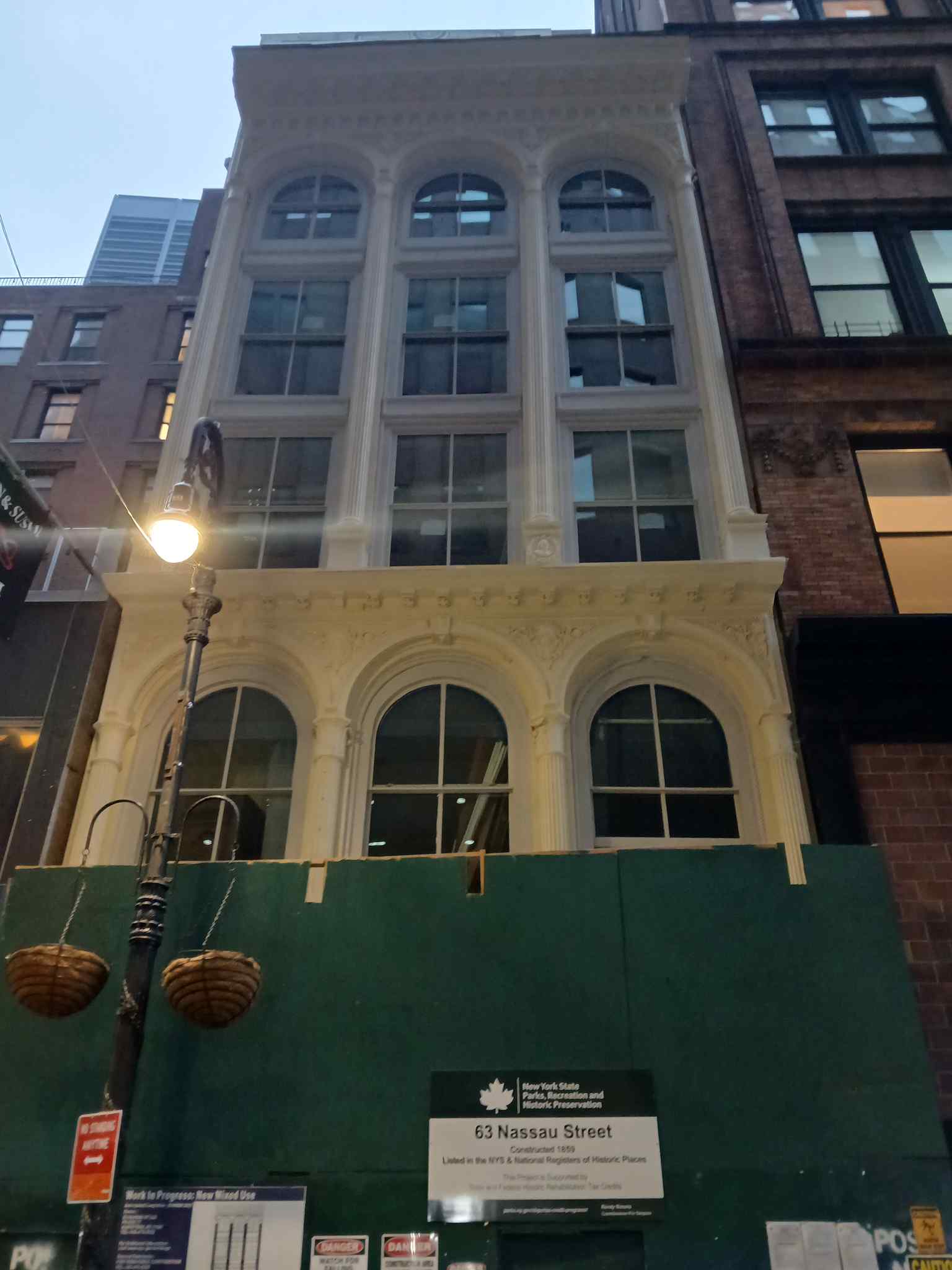 Between the second and third floors, empty spaces mark where wreath-encircled portraits of George Washington were once cast into the facade, mysteriously removed sometime in the 1970s.