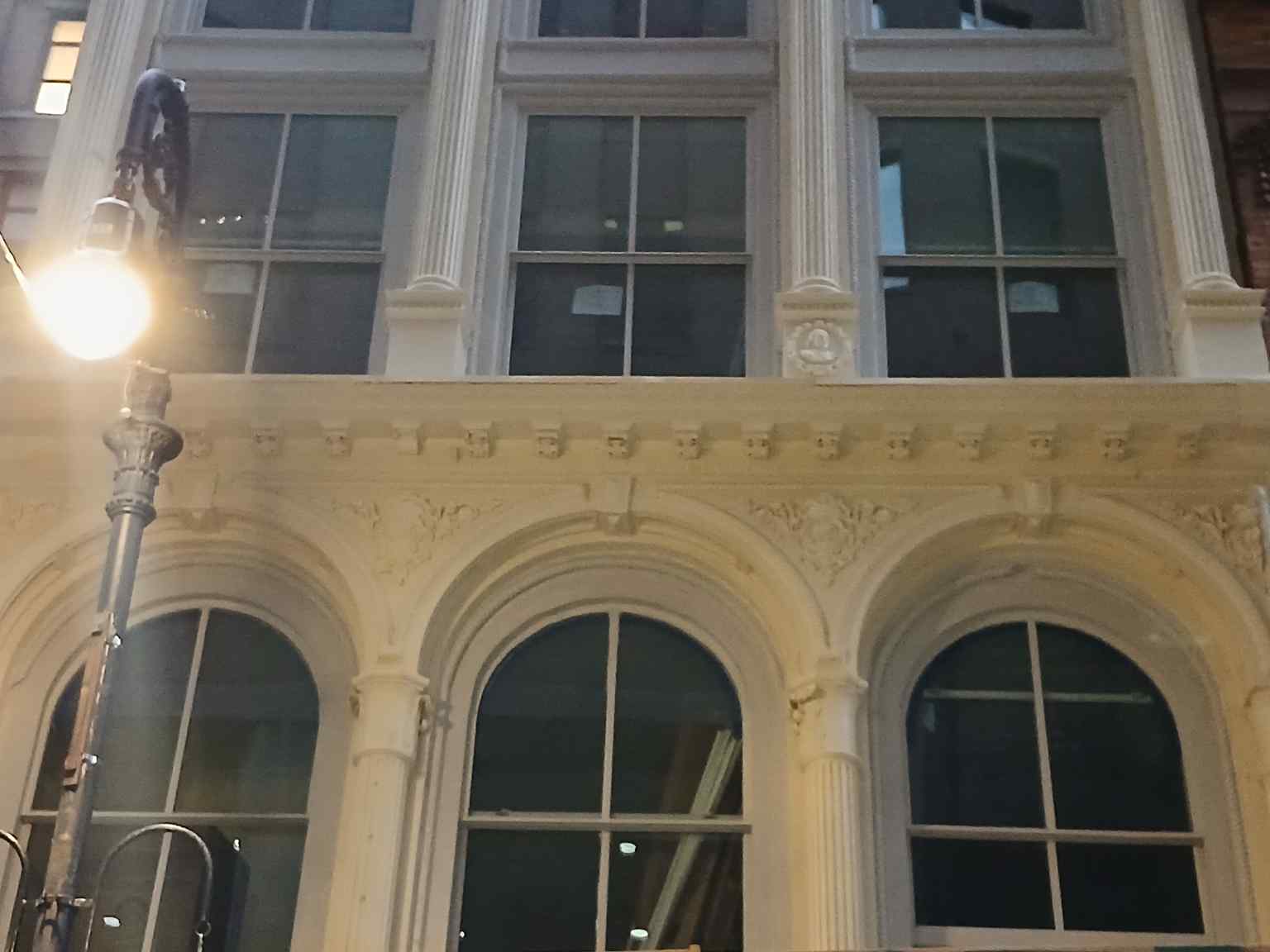 The ground floor of 63 Nassau Street shows significant alterations from 1919 onwards, including a deeply recessed northern entrance with a mosaic tile floor and a non-historic southern metal-and-glass storefront.