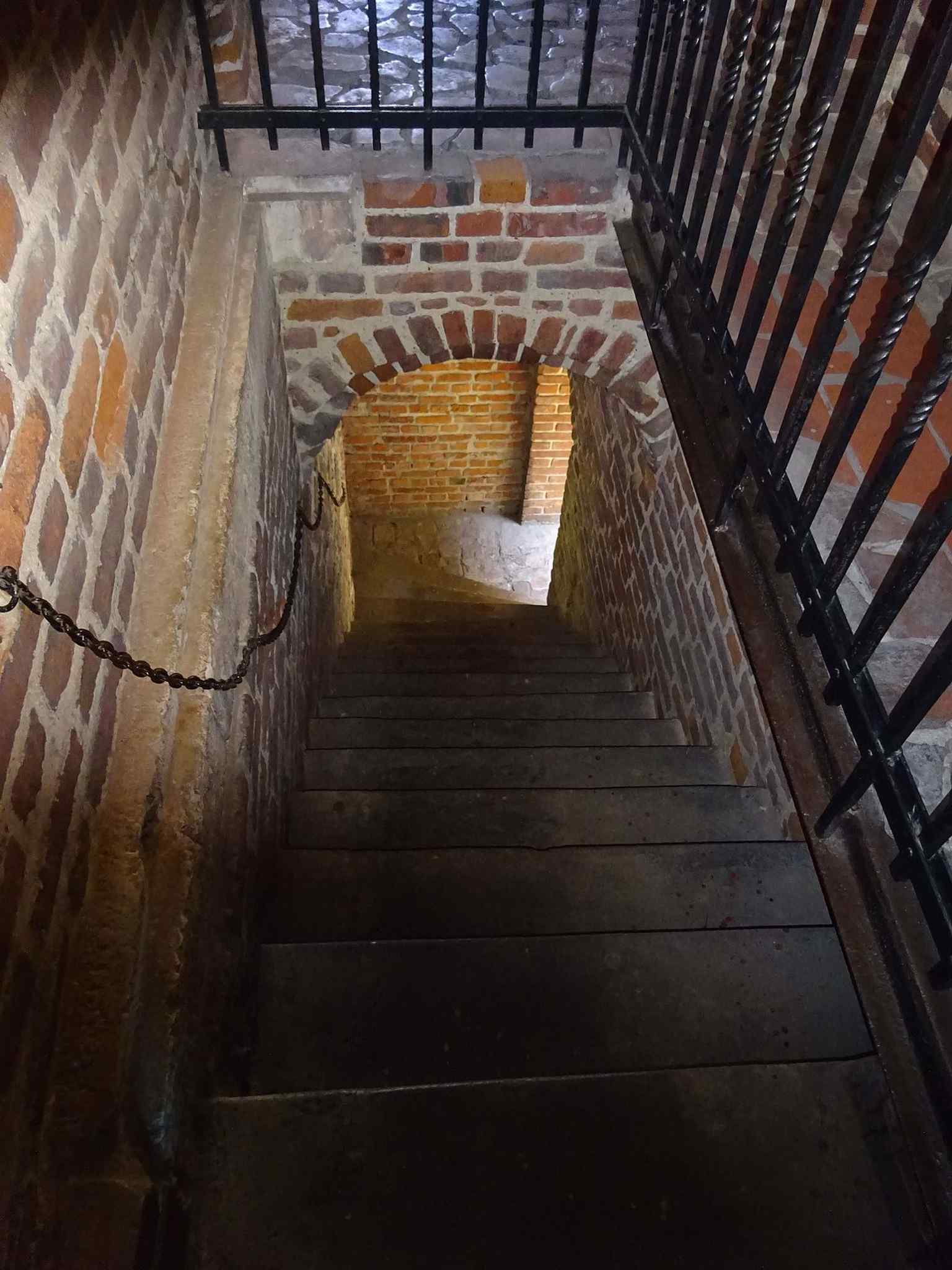 A stair to the balcony reveals the layered defensive structure of the Barbican, including walkways used by guards above the walls.