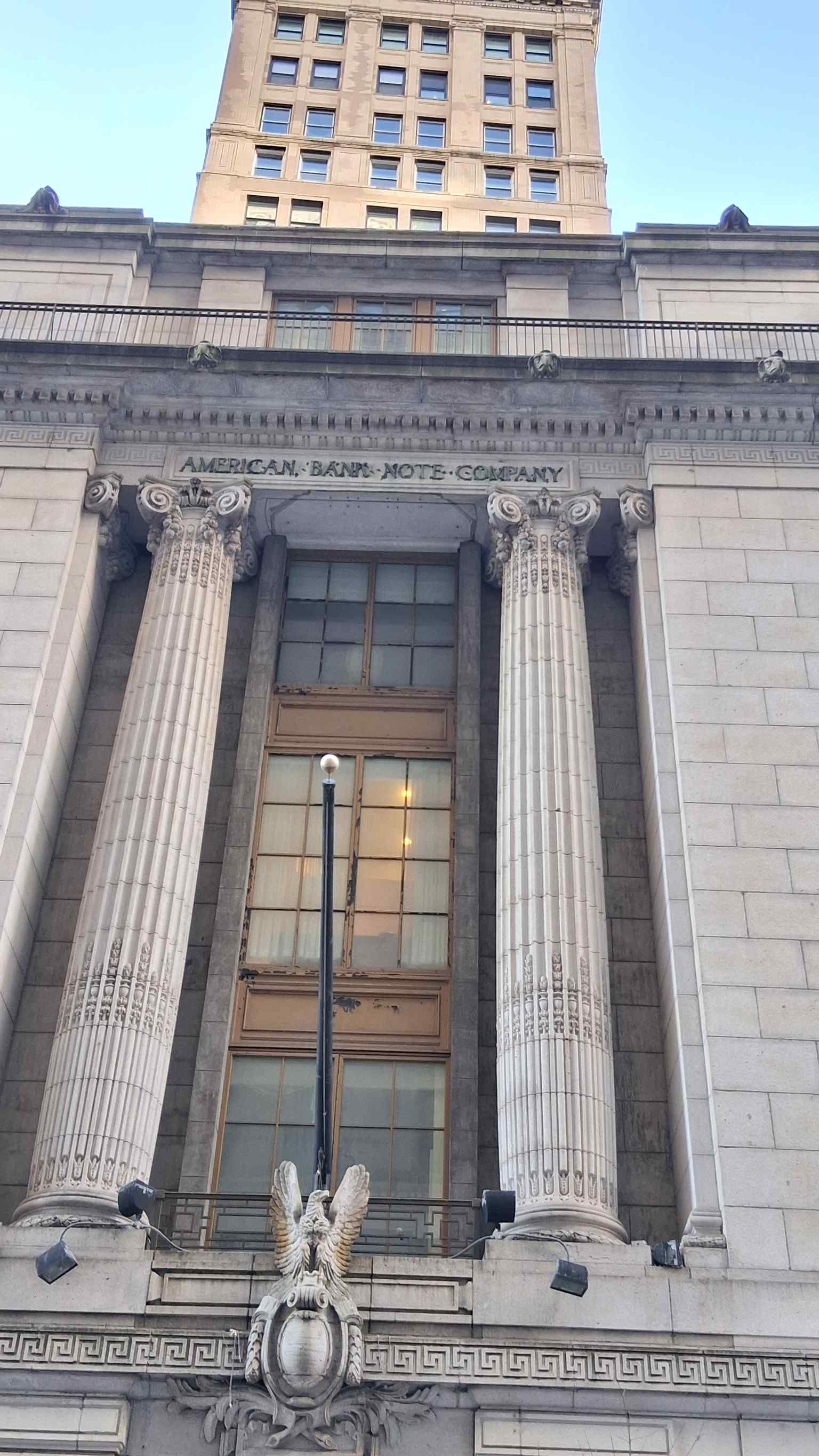 This modern exterior view showcases the five-story neoclassical design, featuring two prominent fluted Corinthian columns on Broad Street.