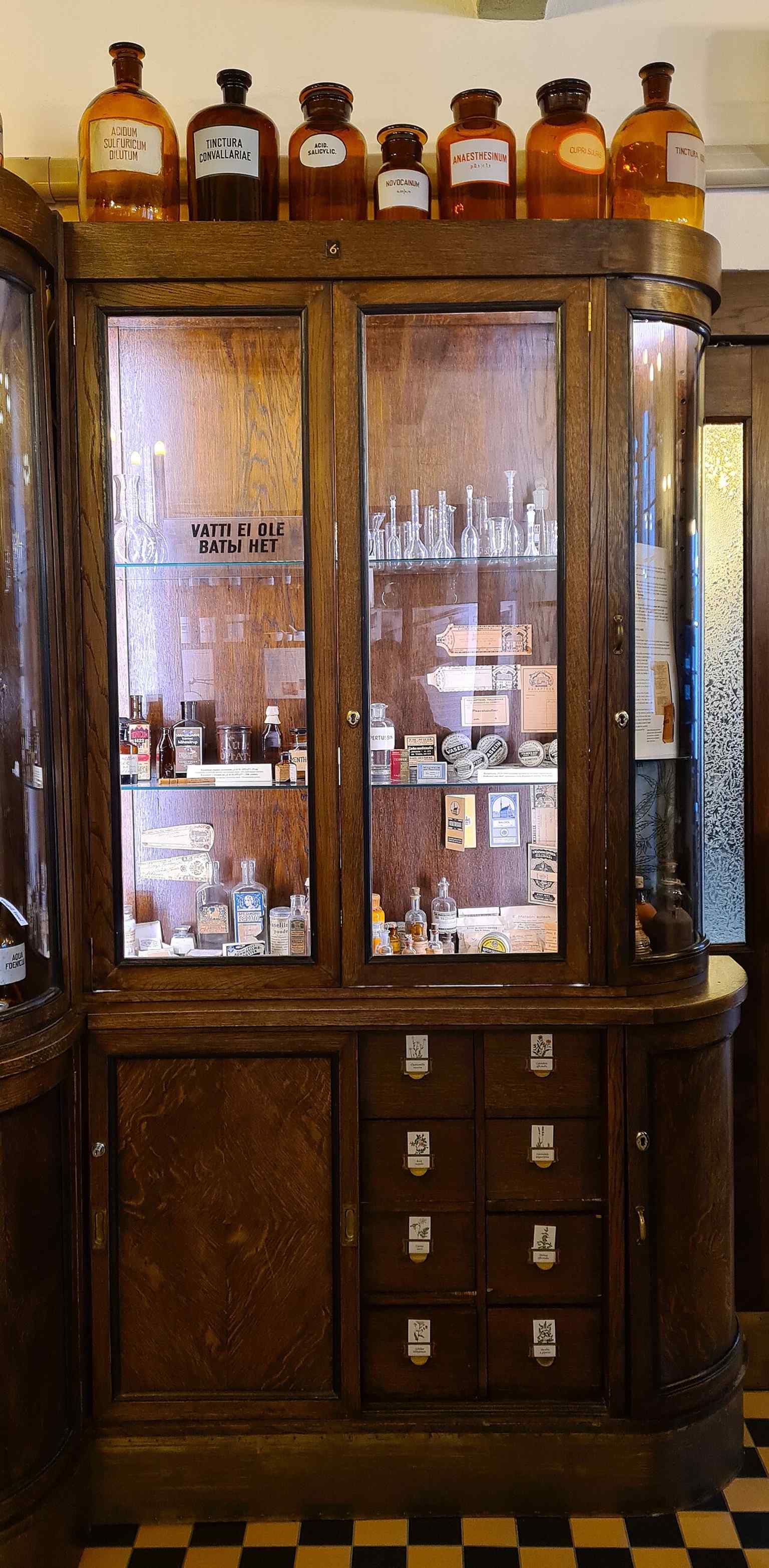 An interior detail that fits the pharmacy’s collection of old medicinal objects, documents, and curiosities linked to the Burghart era.