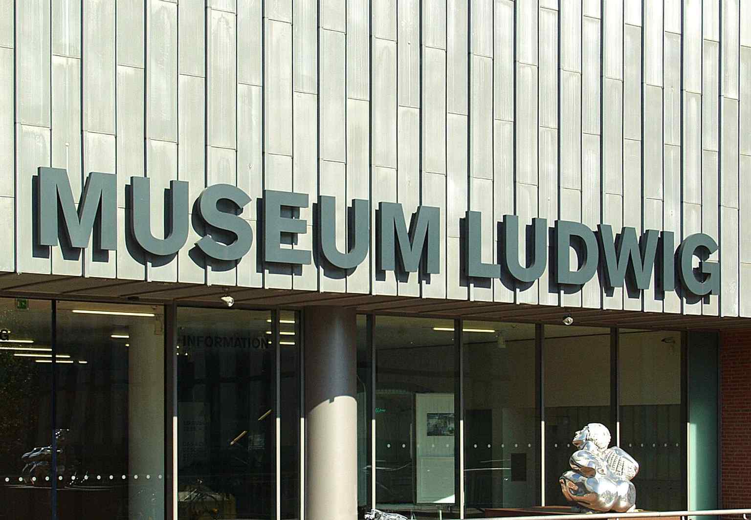 The clear signage above the southern entrance welcomes visitors to Museum Ludwig, founded to house two major collections under one roof.