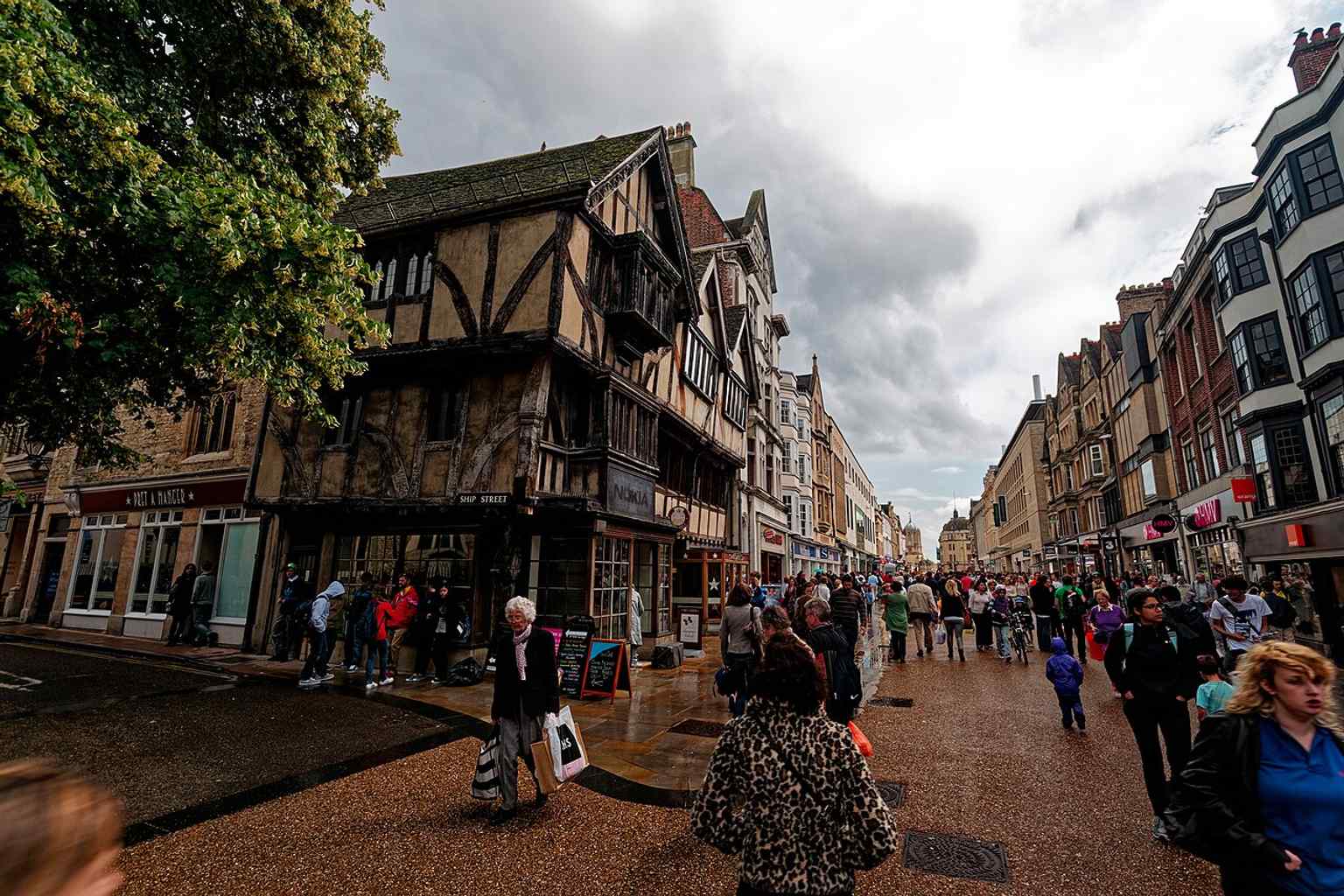 Cornmarket by Ship Street, near the 14th-century timber-framed New Inn at 26–28 Cornmarket on the corner.