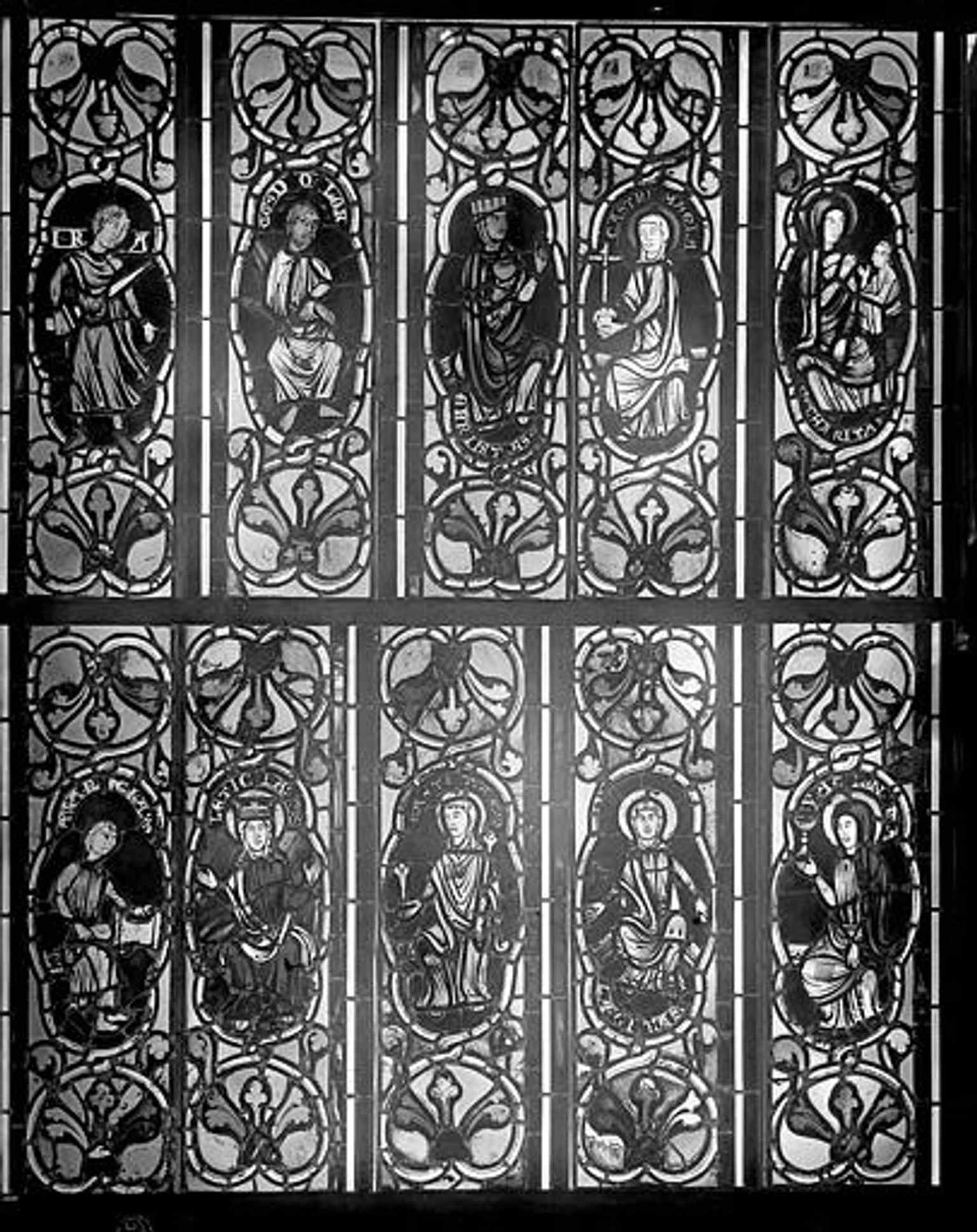 A close stained-glass view of saintly figures, showing the devotional imagery that fills the cathedral’s chapels and choir.