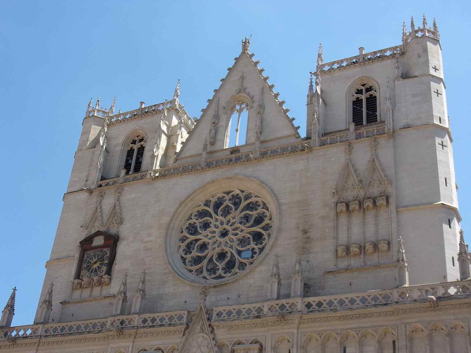The cathedral’s western front in daylight, a strong overall exterior shot that shows the gothic massing and the square built into the Vieux Lyon streetscape.
