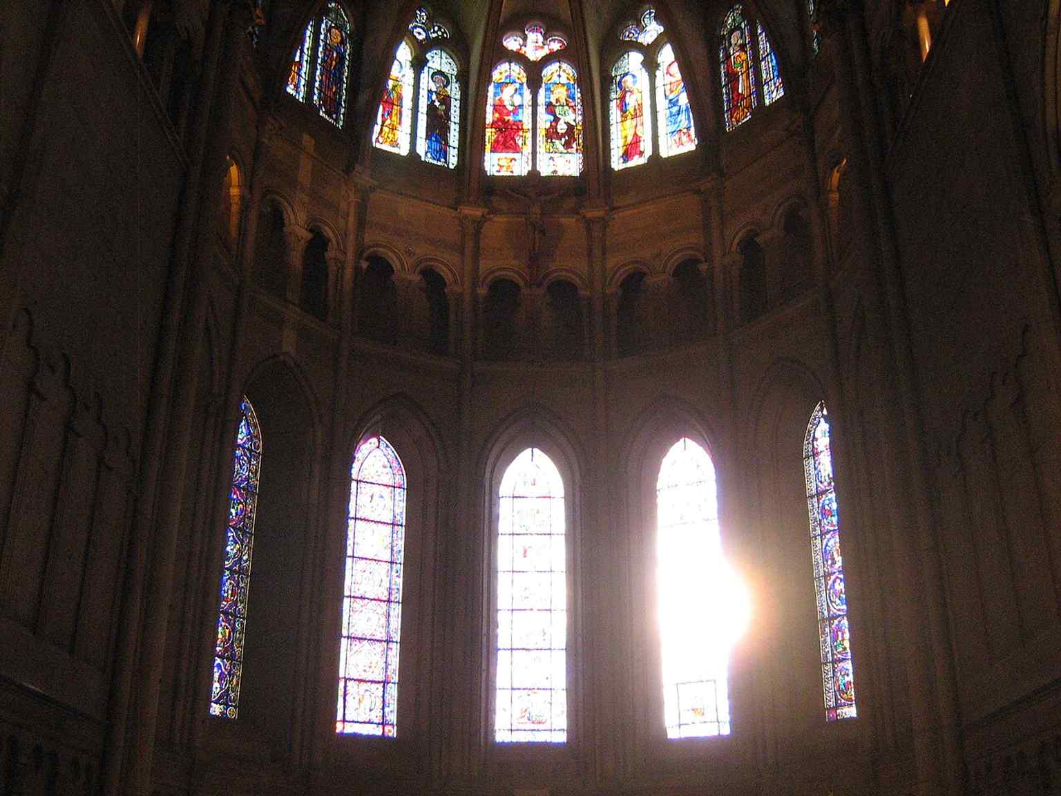 Sunrise glowing through the choir windows, highlighting the cathedral’s stained glass and the luminous eastern end of the church.