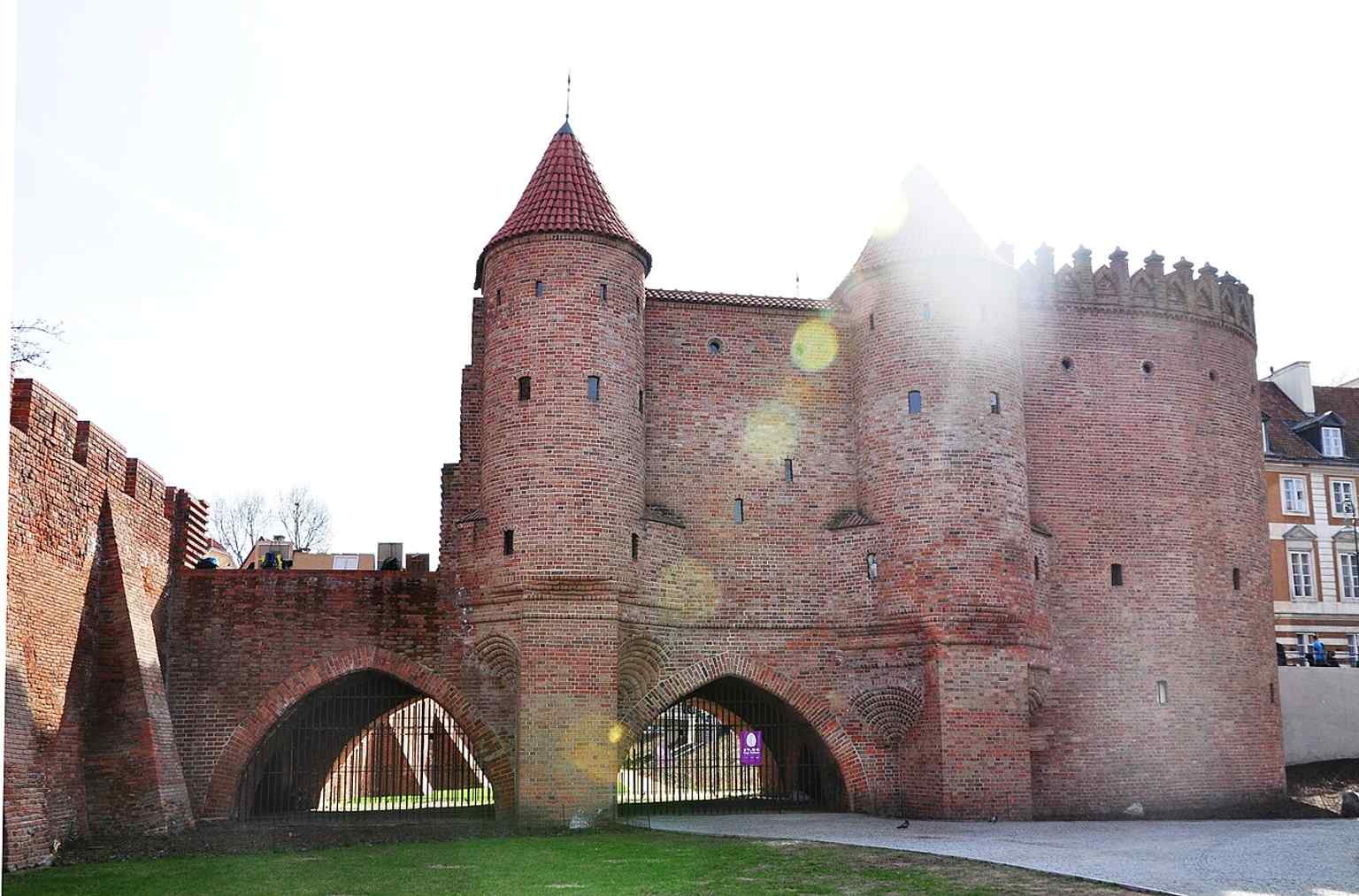 A strong east-side view of the Warsaw Barbican, showing the brick fortification that once guarded the New Town Gate.