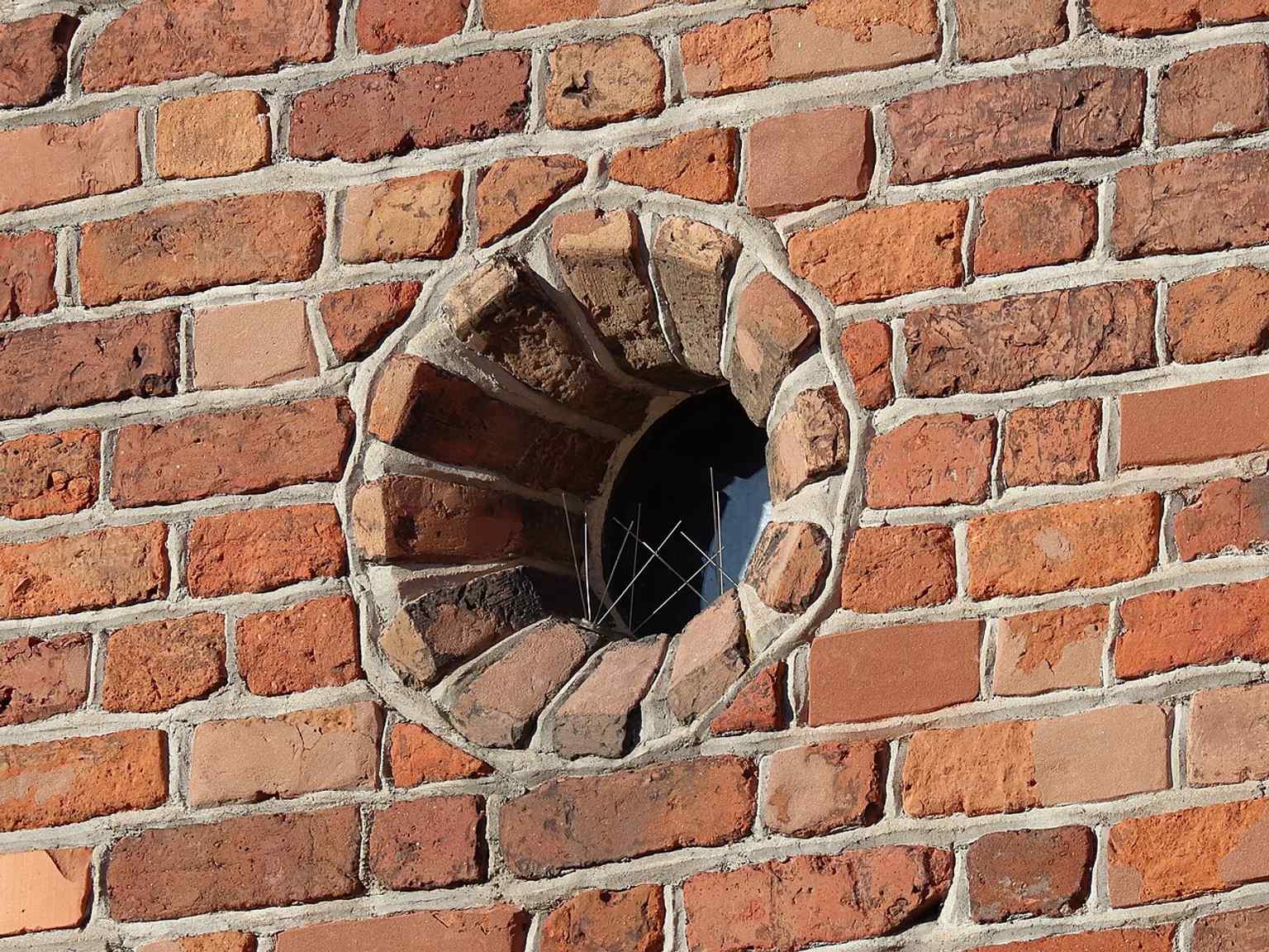 The Barbican’s round loophole window, echoing the defensive openings described in the original fortified structure.