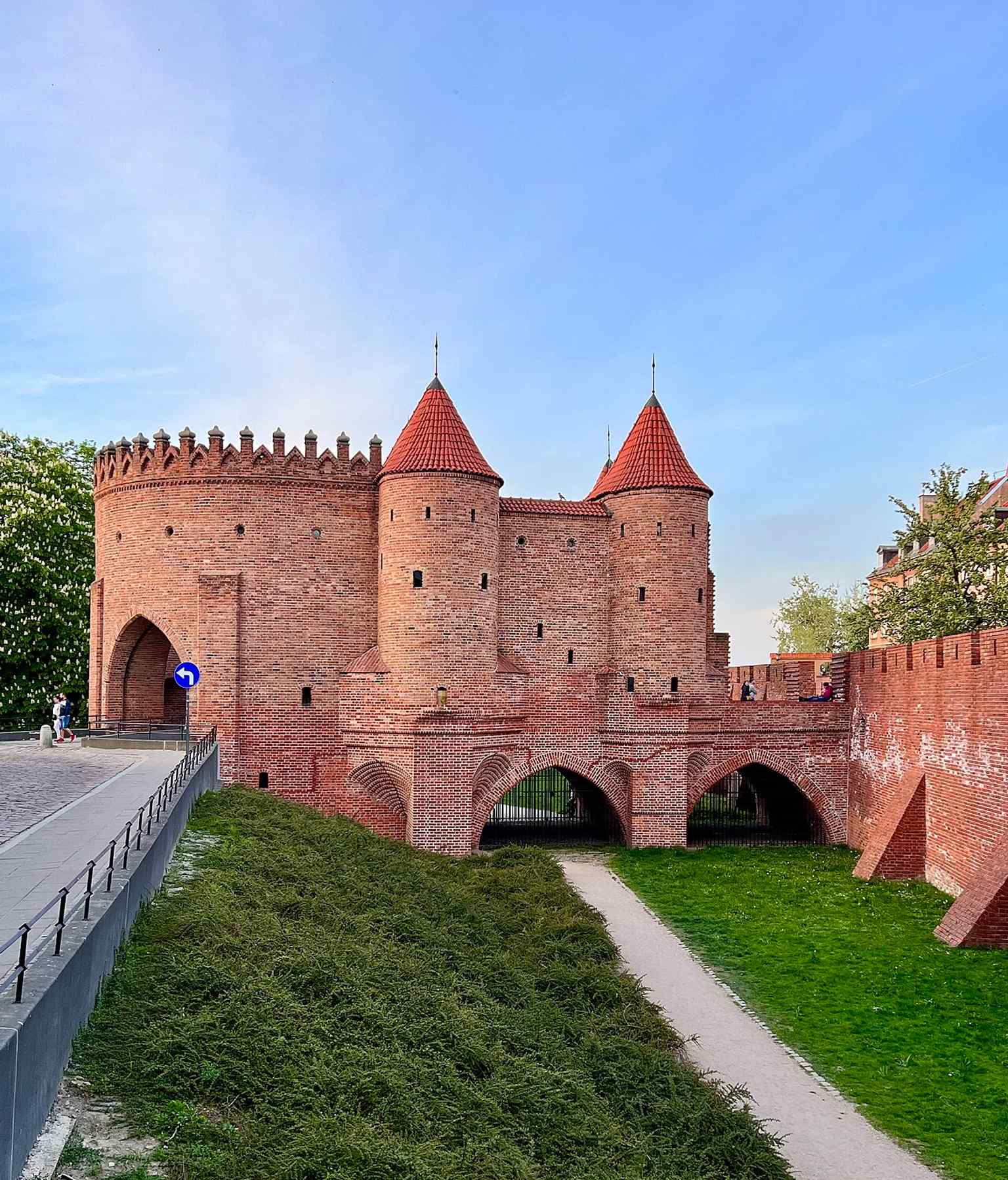 The Barbican and Warsaw Old Town walls together, showing the broader defensive system it was built to protect.