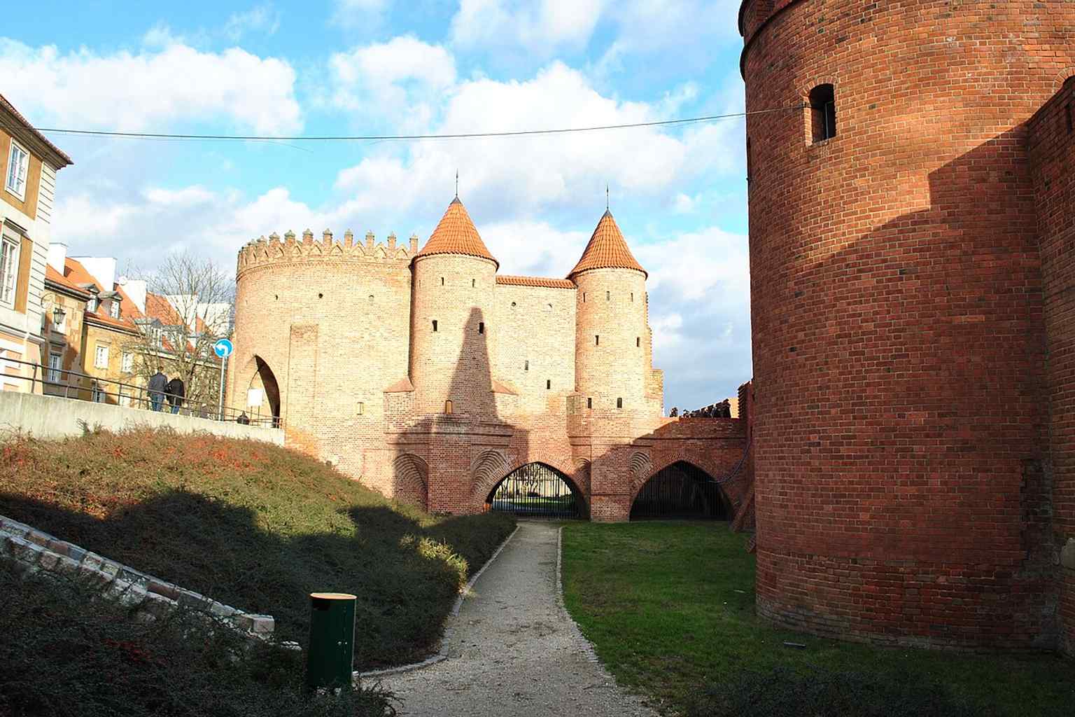 A street-level view from Podwale and Nowomiejska, where the Barbican once linked directly to the city’s gate approach.