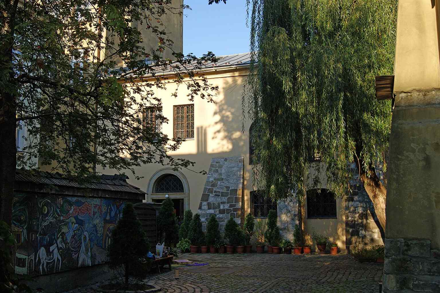 A wide exterior view of the historic building, useful for showing its scale and setting in Kazimierz.