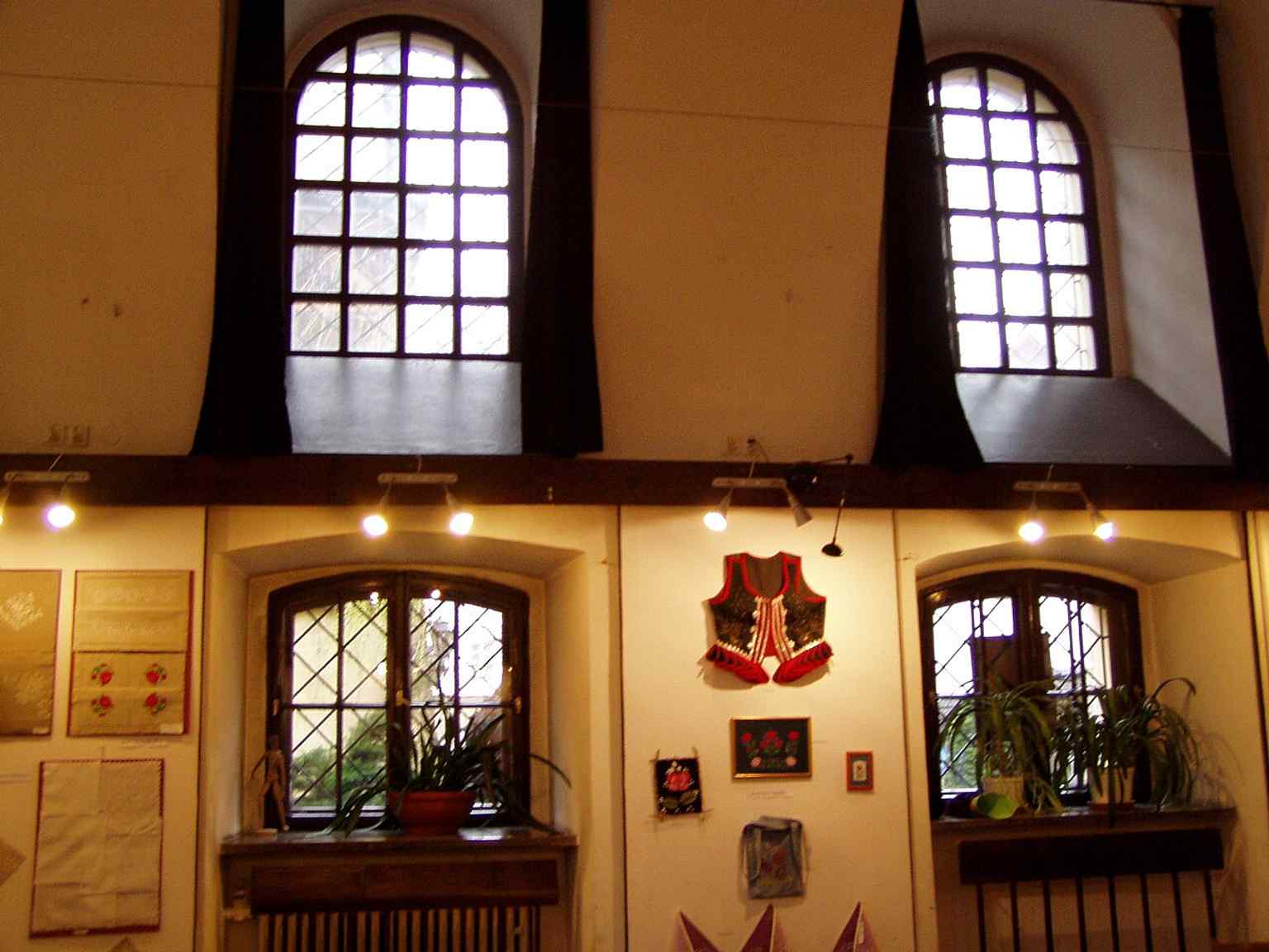Windows on the building’s upper level, near the former women’s area that was later adapted for other uses.