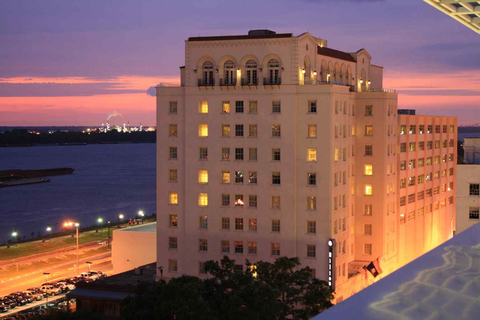 The grand exterior of the Hilton Baton Rouge Capitol Center, originally built as the Heidelberg Hotel in 1927. Noted architect Edward F. Neild famously sketched his initial vision for this ten-story Romanesque skyscraper on a napkin.