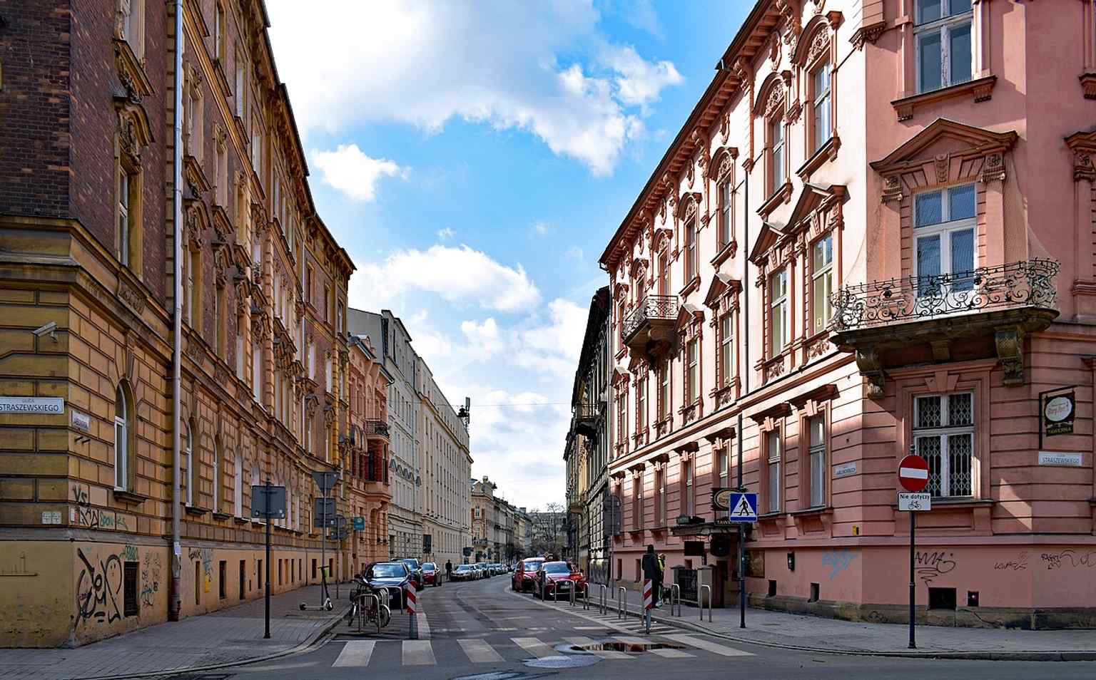 A wide westward view of Jabłonowskich Street showing its calm late-19th-century urban frontage near Planty, where the city expanded onto former Jabłonowskich family land.