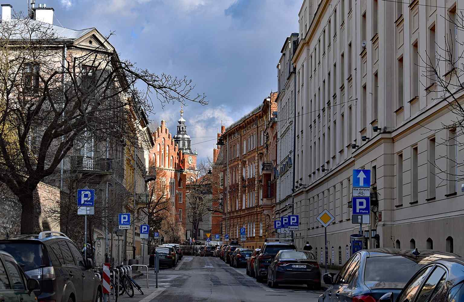 Looking east along the street, this modern panorama helps place the route in the historic New Town area of Kraków and shows the street’s continuous residential character.