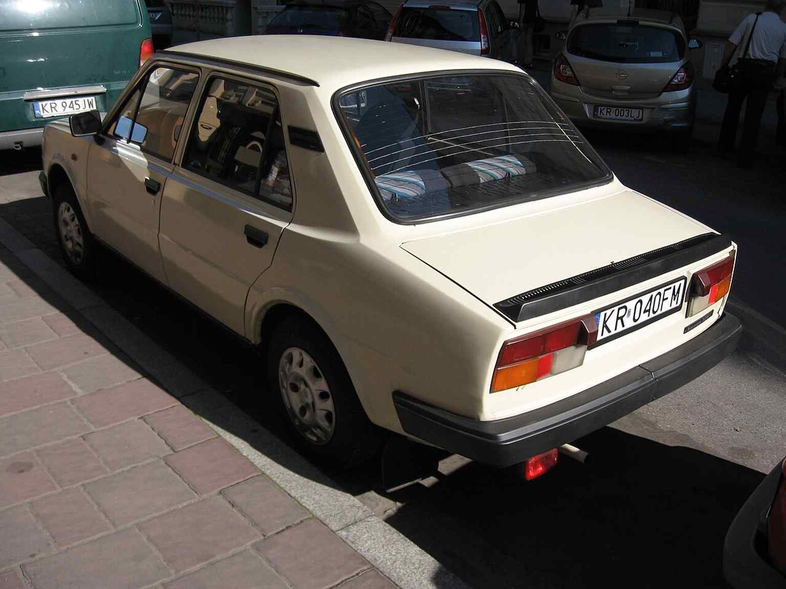 A preserved 1980s Škoda parked on Jabłonowskich Street, adding a street-level detail that captures the everyday atmosphere beyond the architecture.
