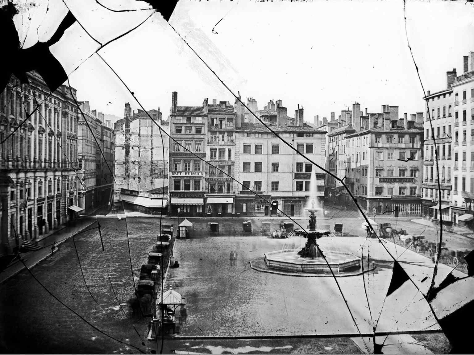 An 1856 view of the square during Haussmann-style widening works, with an earlier monumental fountain already in place.