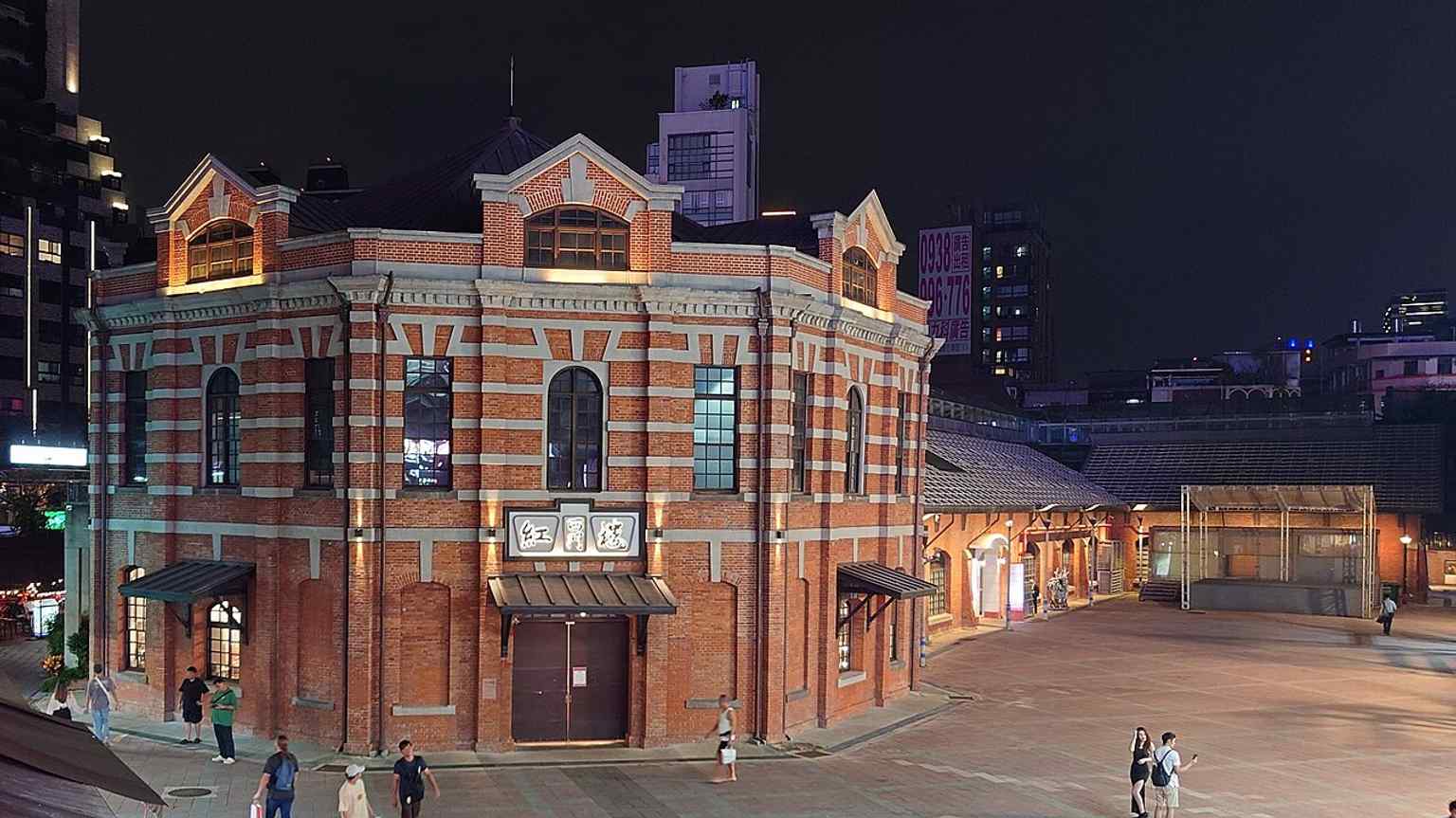 Night view of Ximen Red House, now a cultural and performance venue — a vivid reminder of how the site evolved from market to theater and creative hub.