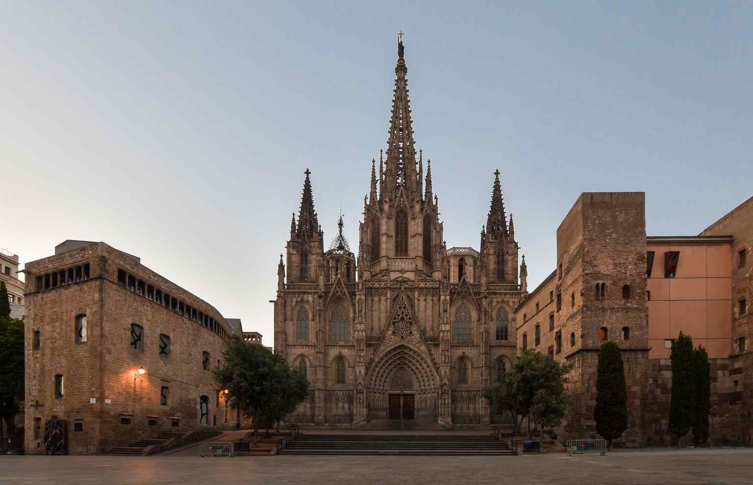 The soaring Neo-Gothic facade of the Barcelona Cathedral bathed in the warm light of sunrise (2019).