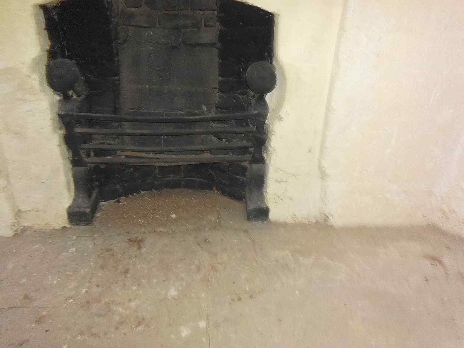 A downstairs fireplace inside the tower, one of the domestic details from its later use as a museum and storehouse.