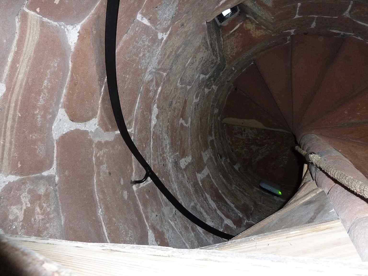 The ground-floor stairwell illustrates the narrow vertical circulation inside the tower’s two-stage interior.