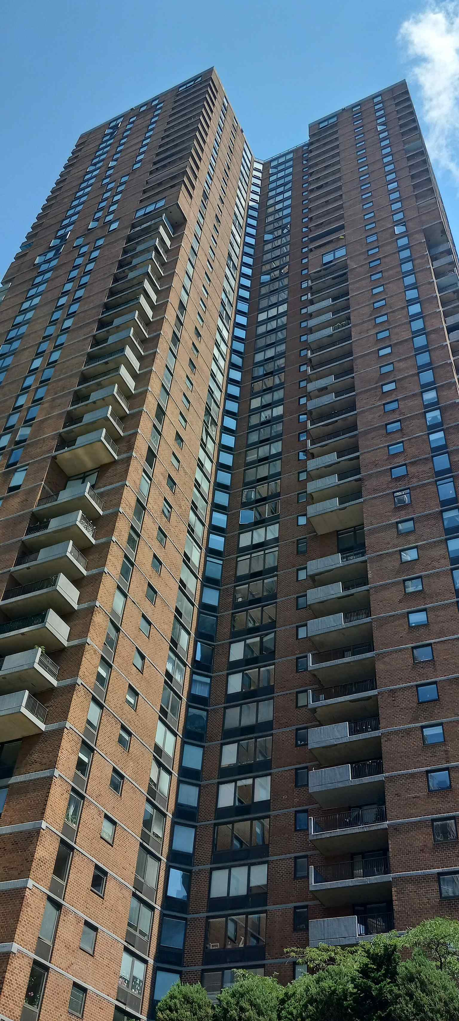 This image shows the exterior of Manhattan Plaza, a 46-floor residential complex designed by David Todd that became home to performing artists and local residents.