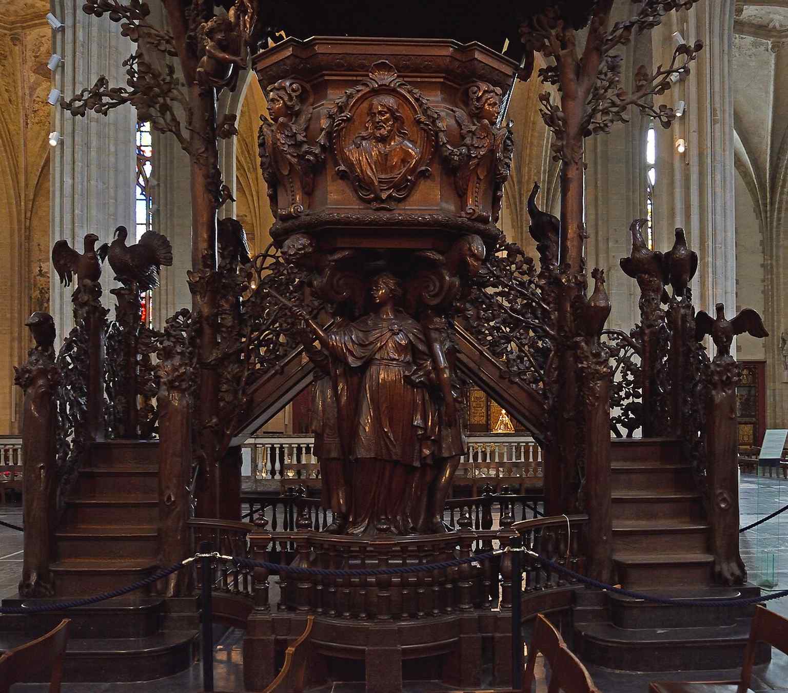 Michel van der Voort’s dramatic wooden pulpit turns the sermon itself into sculpture, with Adam, Eve, and the serpent carved into the base.