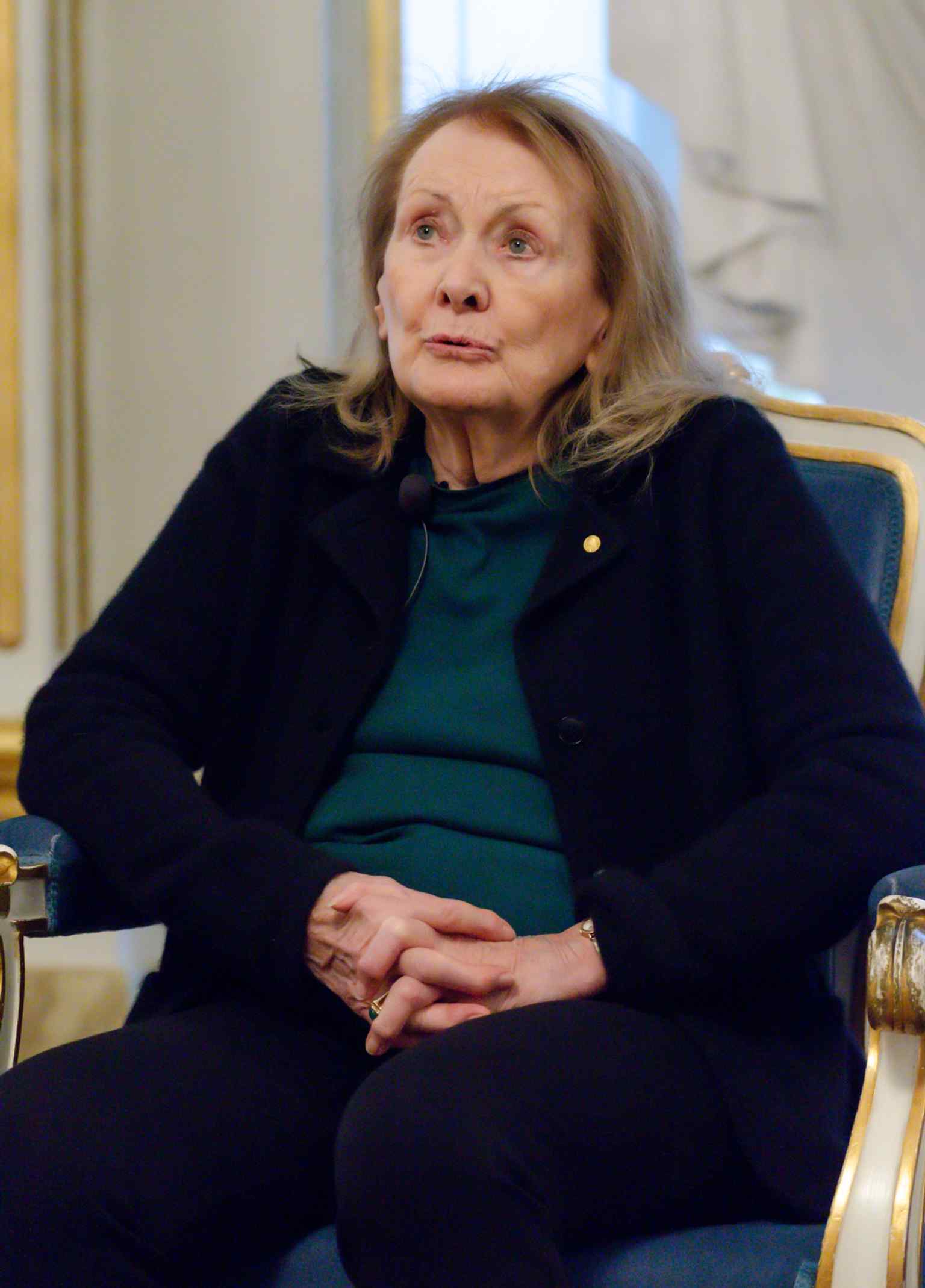Annie Ernaux, the 2022 Nobel Prize in Literature winner, attends a press conference inside Börshuset, illustrating the building's current role as the prestigious home of the Swedish Academy.