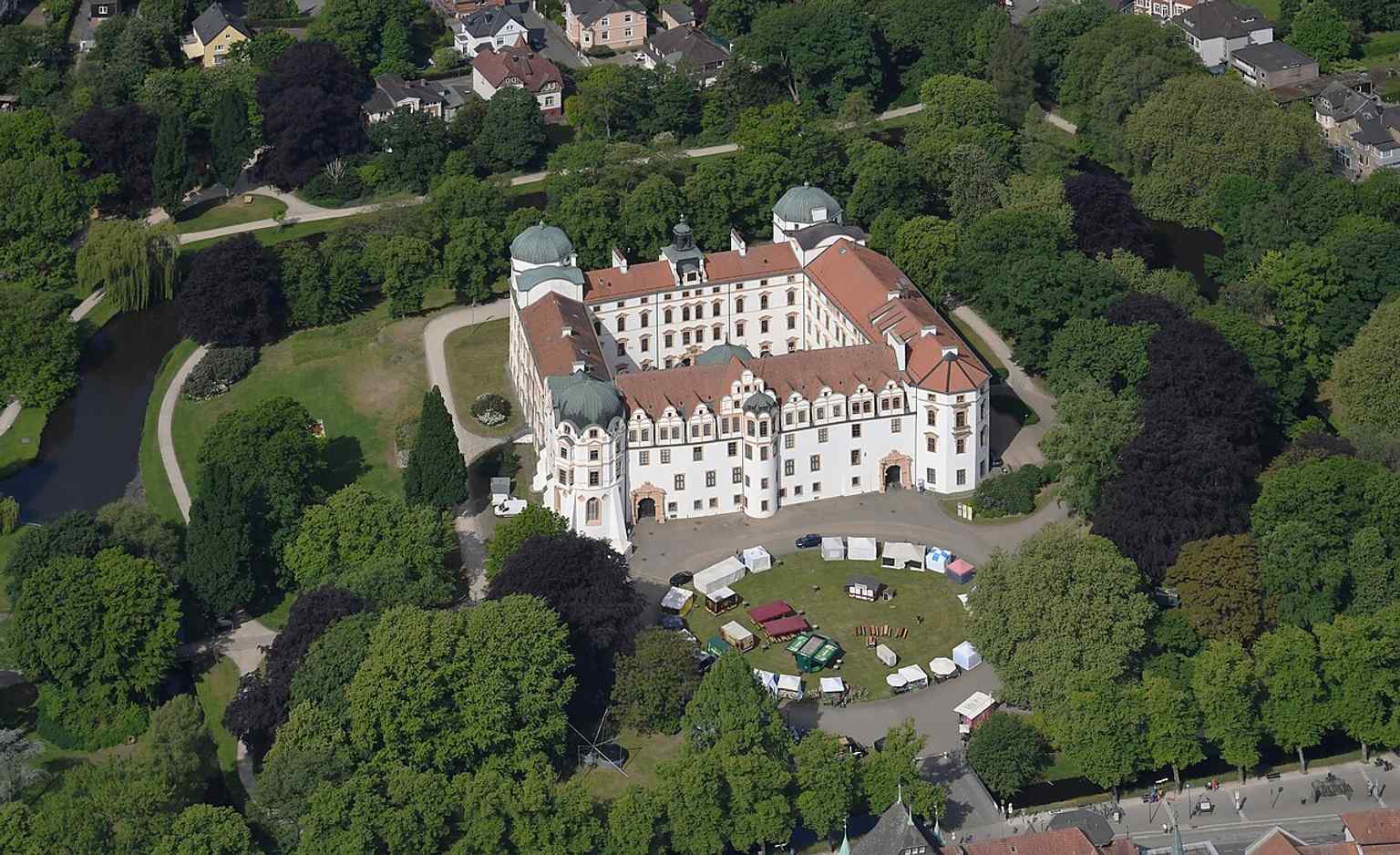 An aerial view of Celler Schloss, illustrating its location on an island surrounded by the castle moat, where outer bastions were later removed to create the surrounding landscape park.