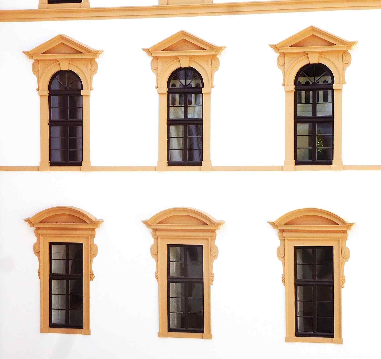 A detailed view of an inner courtyard facade, revealing the specific architectural elements and ornamentation from the Renaissance and Baroque periods, which contributed to its character as a ducal residence.