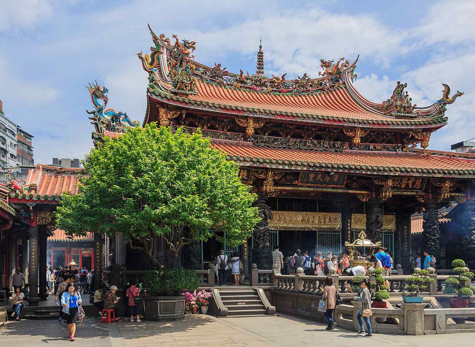 An interior view inside Mengjia Longshan Temple, ideal for showing visitors the lived devotional space rather than just the façade.