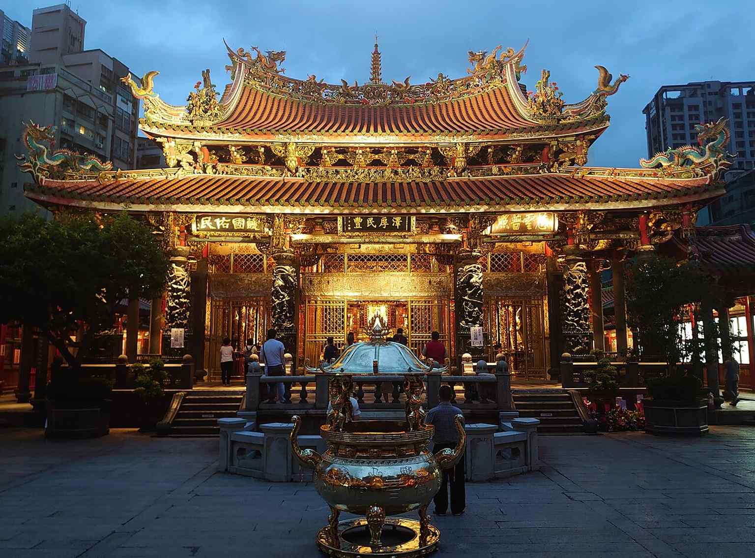 The main hall lit at night — this is the heart of the temple, where Guanyin is worshipped and the building’s rich ornamentation stands out.