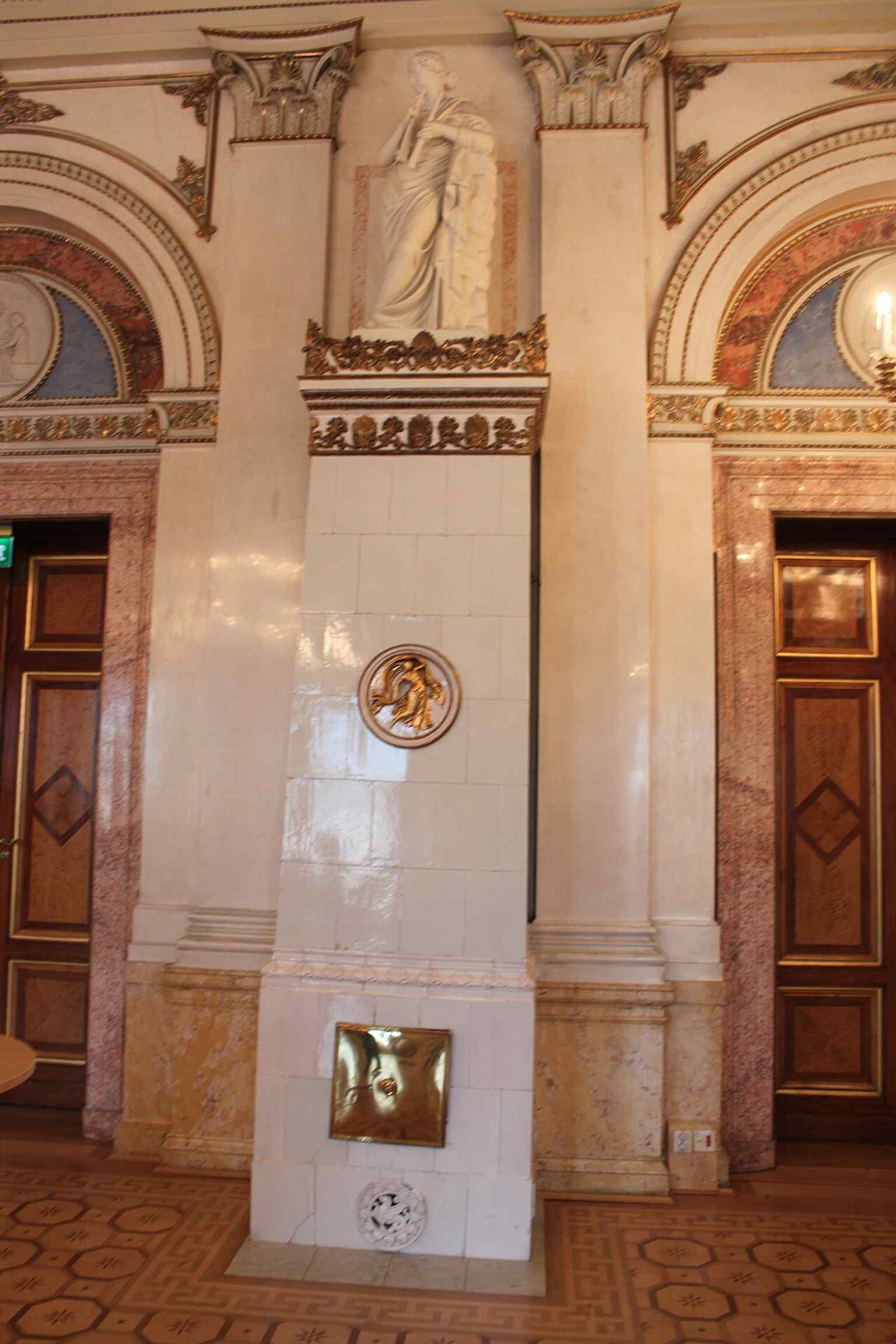 One of the building's ornate tiled stoves, similar to the four found in the Grand Exchange Hall, which are topped with gypsum statues representing muses and truth.