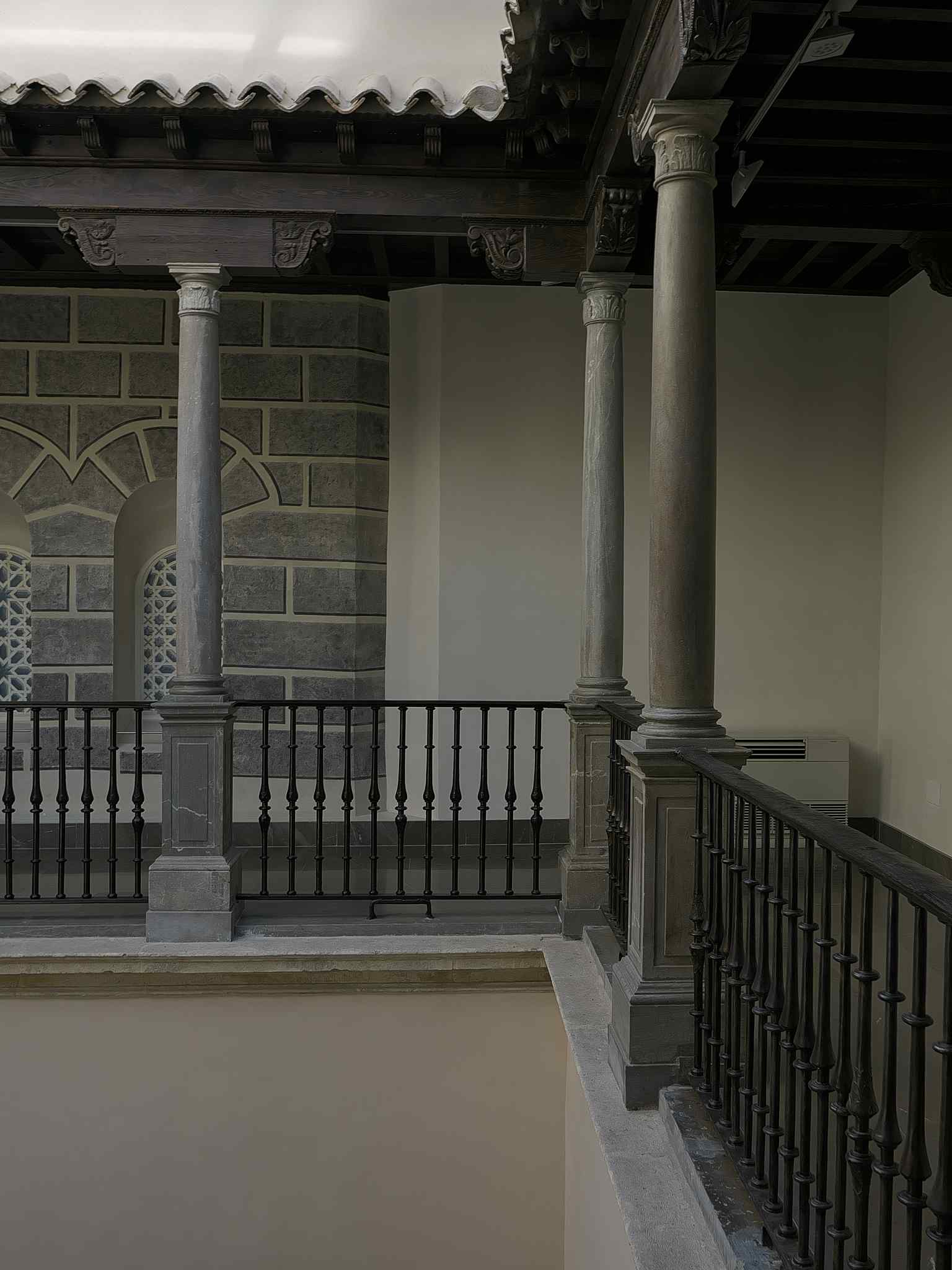 Walk through the upper floor galleries, part of the Madrasa's interior that was largely rebuilt in the Baroque style and later received 19th-century 'Orientalist' restorations.
