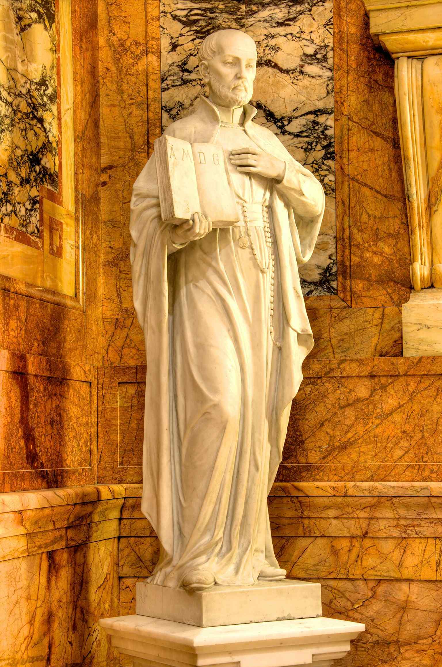 A close-up of the main Altar, crafted from Pavonazzo marble and gilt-bronze, which is part of the church's interior decorated with diverse precious marbles.