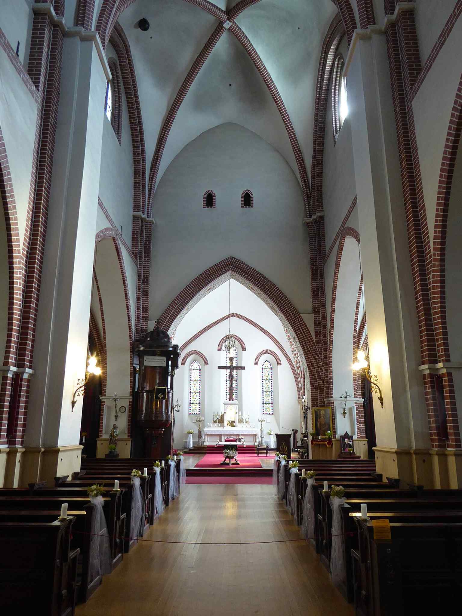 The nave and altar area, where the cathedral’s simple basilica form and layered historic details are visible.