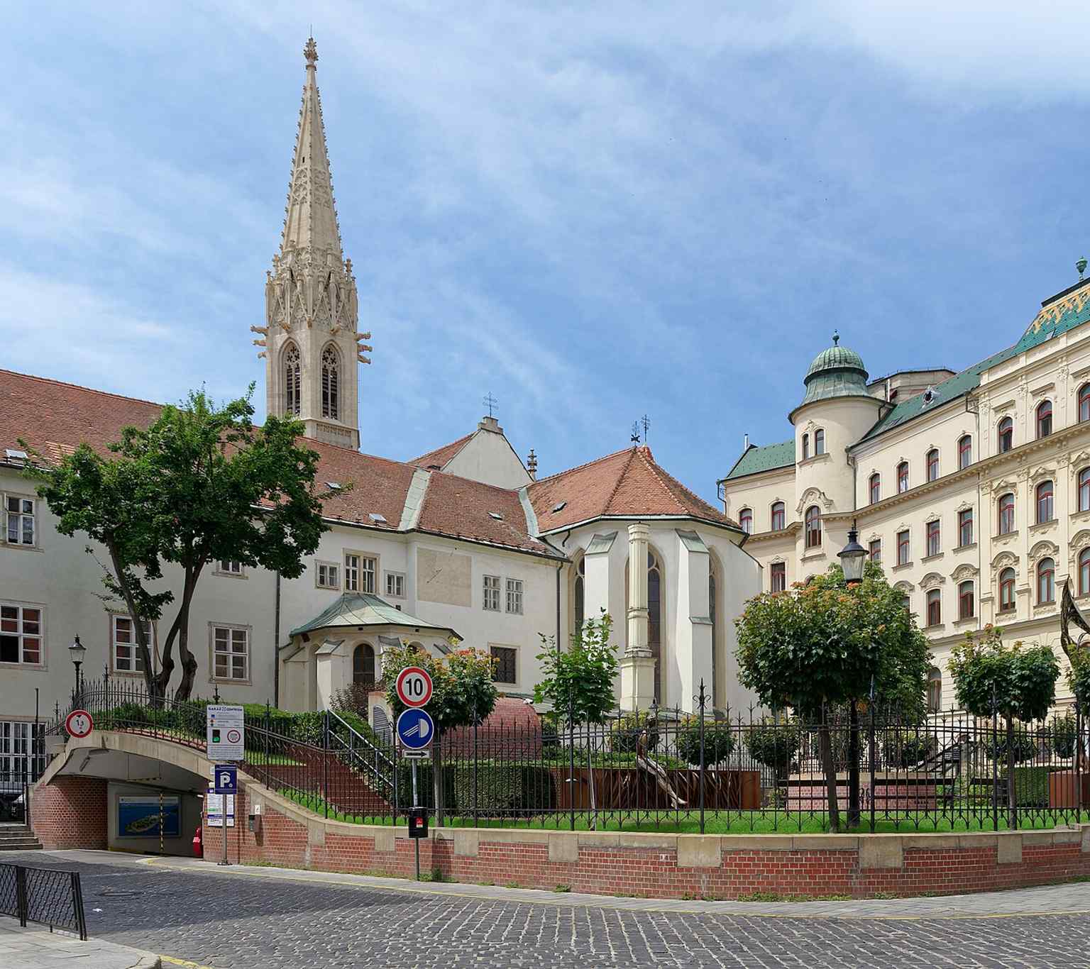 A wider view of the Franciscan Church exterior, showing the main façade and the attached monastery complex in the Old Town.