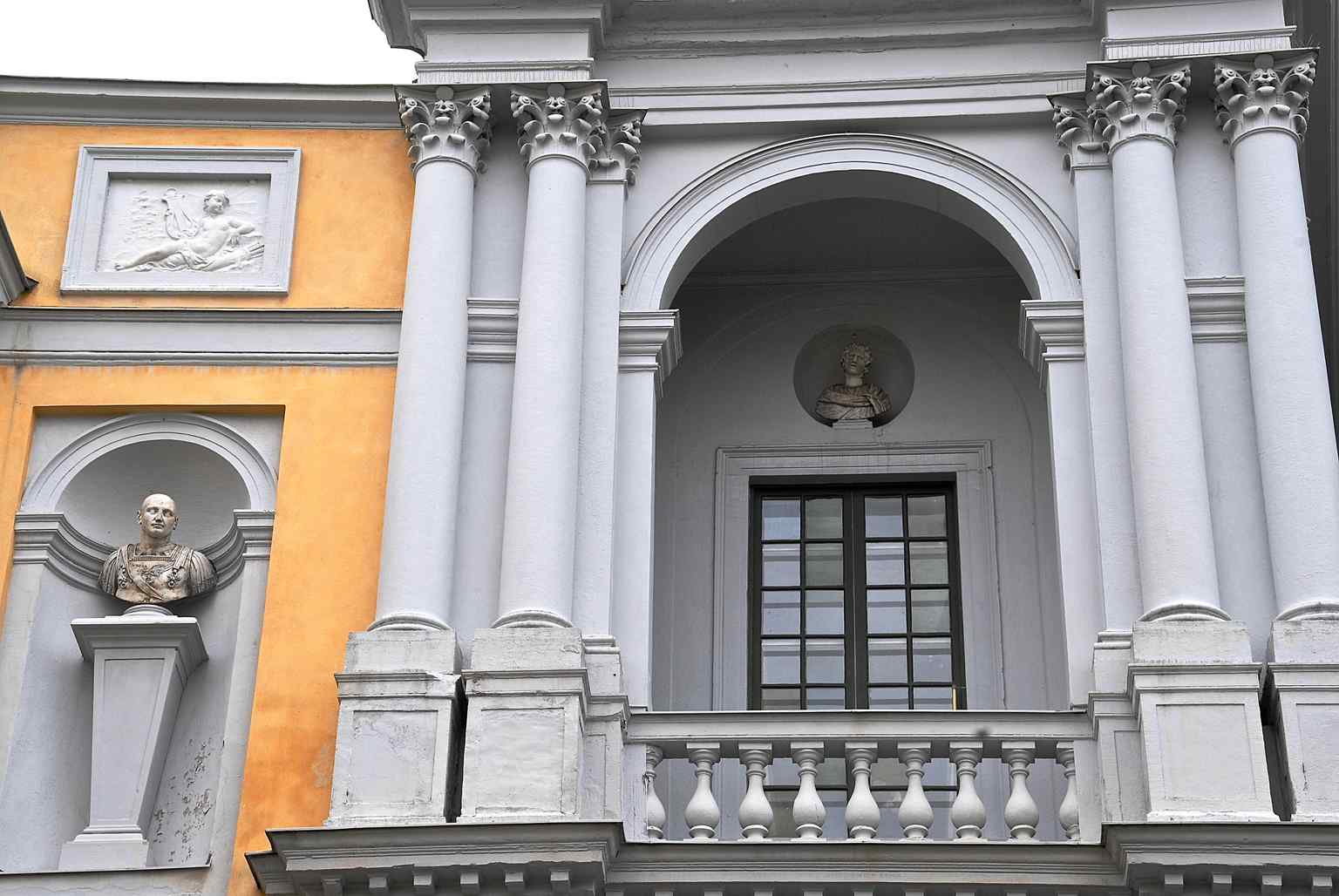 The palace's facade with its warm yellow smooth plaster on the upper floors and rusticized grey ground floor, reflecting Tessin's Roman-inspired Baroque design.